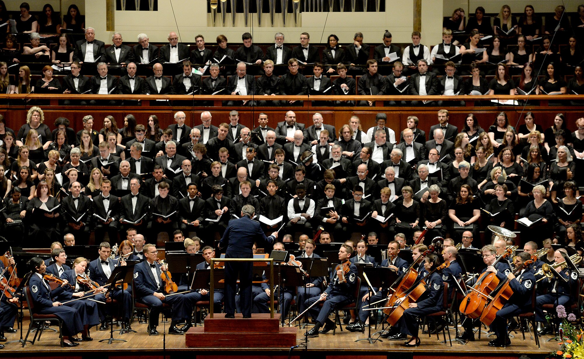 Retired Col. Arnald Gabriel conducts a special Memorial Day concert performance by the by Air Force Symphony at the John F. Kennedy Center for the Performing Arts May 24, 2015, in Washington, D.C. Gabriel served in the Army as a combat machine gunner and landed in Normandy, France, on D-Day with the 29th Infantry Division.  He later became an Air Force officer and served with the U.S. Air Force Band.  Gabriel retired as the band's commander in 1985. (U.S. Air Force photo/Scott M. Ash)