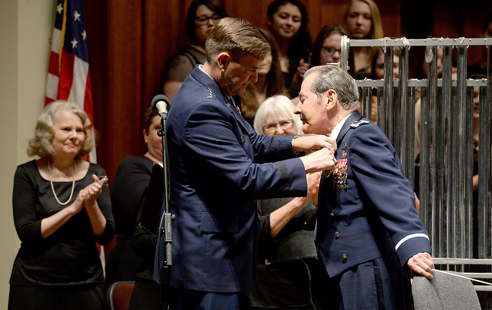 Air Force Assistant Vice Chief of Staff Gen. Stephen Hoog pins the Exceptional Service Medal on the coat of retired Col. Arnald Gabriel, after he conducted a special Memorial Day concert performance by the by Air Force Symphony at the John F. Kennedy Center for the Performing Arts May 24, 2015, in Washington, D.C. Gabriel served in the Army as a combat machine gunner and landed in Normandy, France, on D-Day with the 29th Infantry Division.  He later became an Air Force officer and served with the U.S. Air Force Band.  Gabriel retired as the band's commander in 1985. (U.S. Air Force photo/Scott M. Ash)