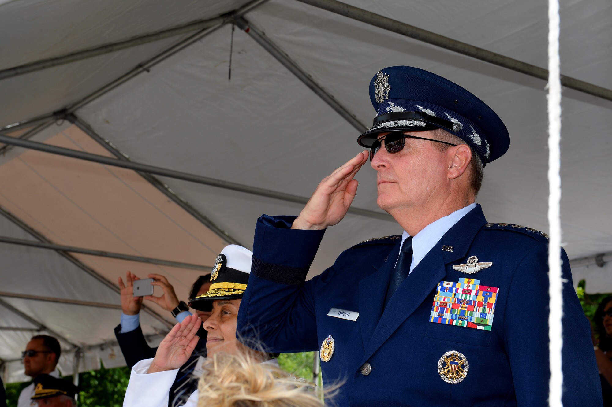Air Force Chief of Staff Gen. Mark A. Welsh III salutes military members marching in the National Memorial Day Parade in Washington, D.C., May 25, 2015. The National Memorial Day Parade was first launched in 2005 by the American Veterans Center in Washington. Welsh also honored American veterans by attending a wreath-laying ceremony in Arlington National Cemetery. (U.S. Air Force photo/Scott M. Ash)