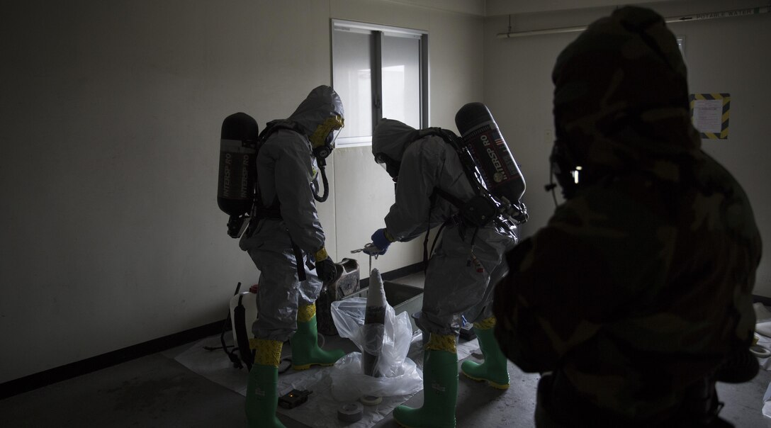 Marines contain a leaking ordnance round during leak, seal, package and decontamination training April 21 at the gas chamber on Camp Hansen, Okinawa. Explosive ordnance disposal technicians and chemical, biological, radiological, nuclear defense specialists placed a leaking ordnance package in the gas chamber, using chlorobenzylidene malonitrile, also known as tear gas, to simulate the emission of harmful gases.  The EOD technicians and CBRN defense specialists used protective equipment to safely contain the leaking ordnance and prepare the package for transport out of the affected area before completing the decontamination process. The training instilled the Marines’ confidence in the safety equipment and procedures used to mitigate CBRN-related hazards. The Marines are with 9th Engineer Support Battalion and Marine Logistics Group Headquarters Regiment, 3rd MLG, III Marine Expeditionary Force.
