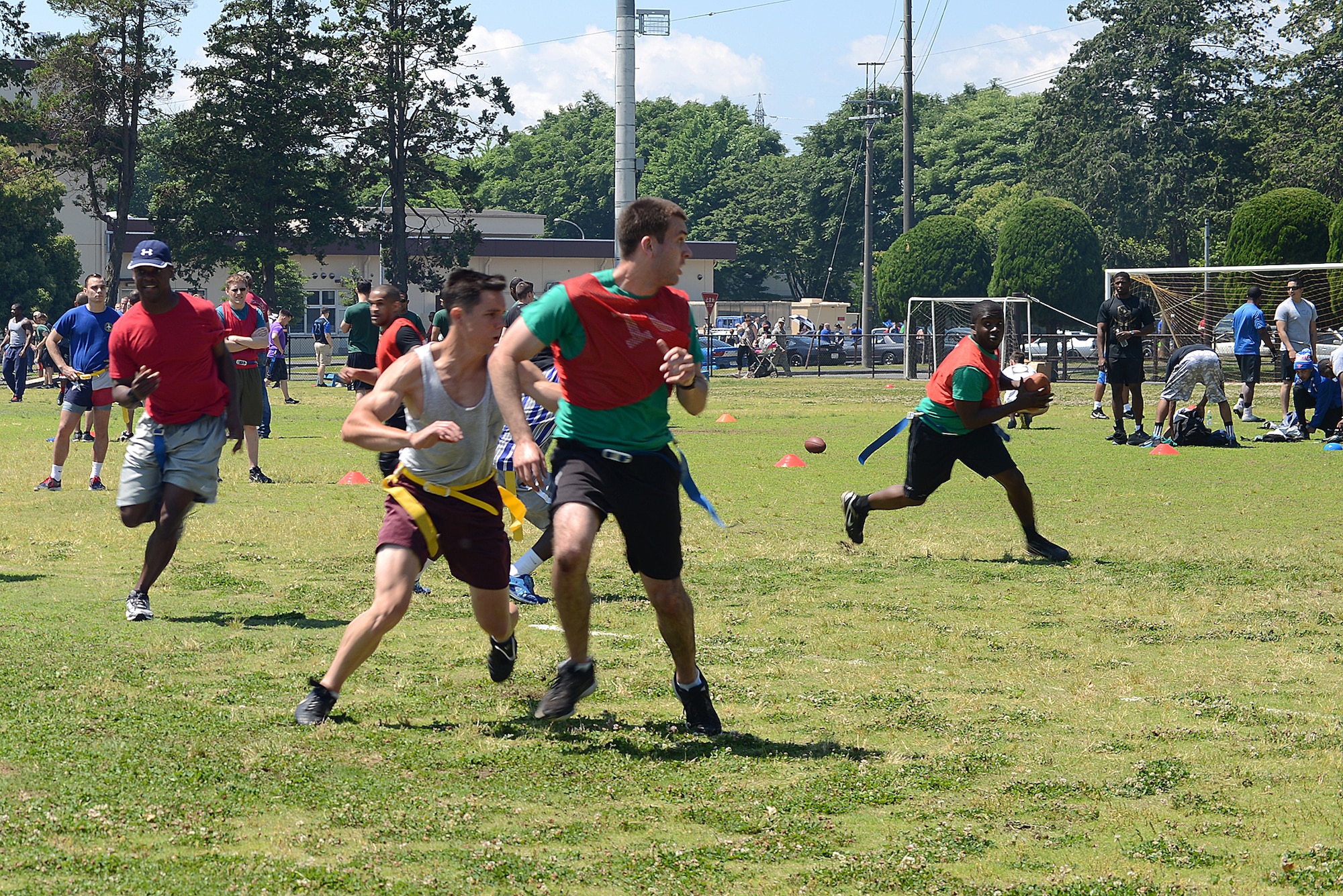 Airmen play a game of flag football during Airman Appreciation Day at Yokota Air Base, Japan, May 21, 2015. During appreciation day squadrons on base compete through a variety of sports to decide an overall winner that receives a trophy and keeps it for a year. (U.S. Air Force photo by Airman 1st Class David C. Danford/Released)