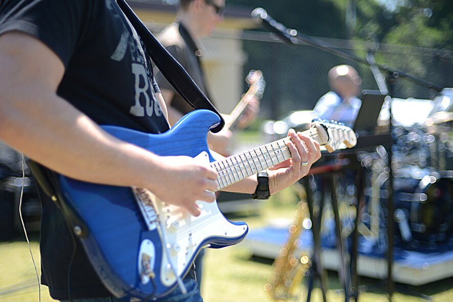 Senior Airman Alberto Rosado-Perez, Band of the Pacific-Asia, Pacific Trends guitarist, performs during Airman Appreciation Day at Yokota Air Base, Japan, May 21, 2015. The free event featured food, sports and live music. (U.S. Air Force photo by Airman 1st Class David C. Danford/Released)
