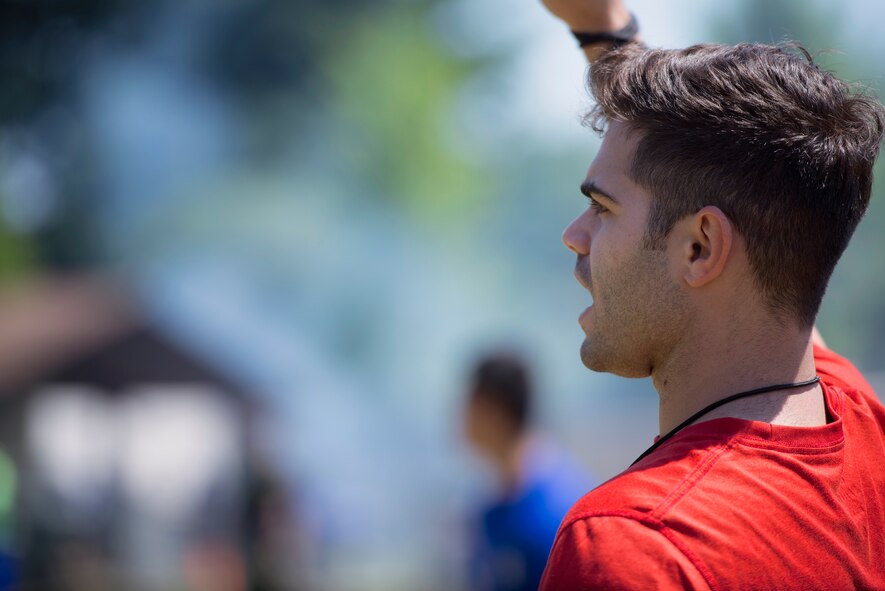Cody Ramirez, 374th Airlift Wing public affairs, referees for a flag football game, May 21, 2015 at Yokota Air Base, Japan. The day provided Airmen a chance to relax and spend time with their friends and family. (U.S. Air Force photo by Airman 1st Class Delano Scott/Released)