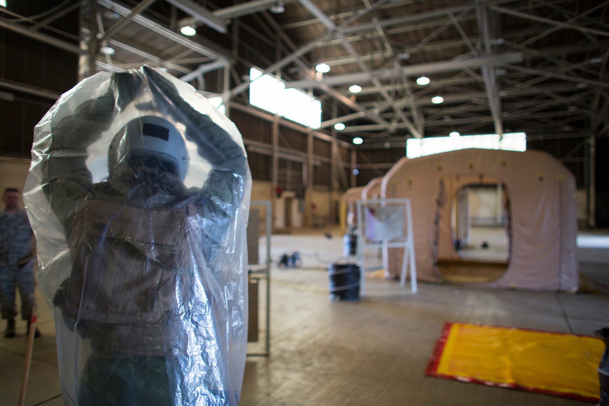 An aircrew member from the 36th Airlift Squadron conducts decontamination training during a Samurai Readiness Inspection at Yokota Air Base, Japan, May 20, 2015. Airmen from the 36th AS and 374th Operations Support Squadron performed aircrew decontamination procedures with the Lightweight Inflatable Decontamination System (LIDS). The LIDS takes about 20 minutes to set up and consists of four stations for rinsing off excess chemicals and a process to dispose of contaminated clothing and aircrew equipment. (U.S. Air Force photo by Osakabe Yasuo/Released)