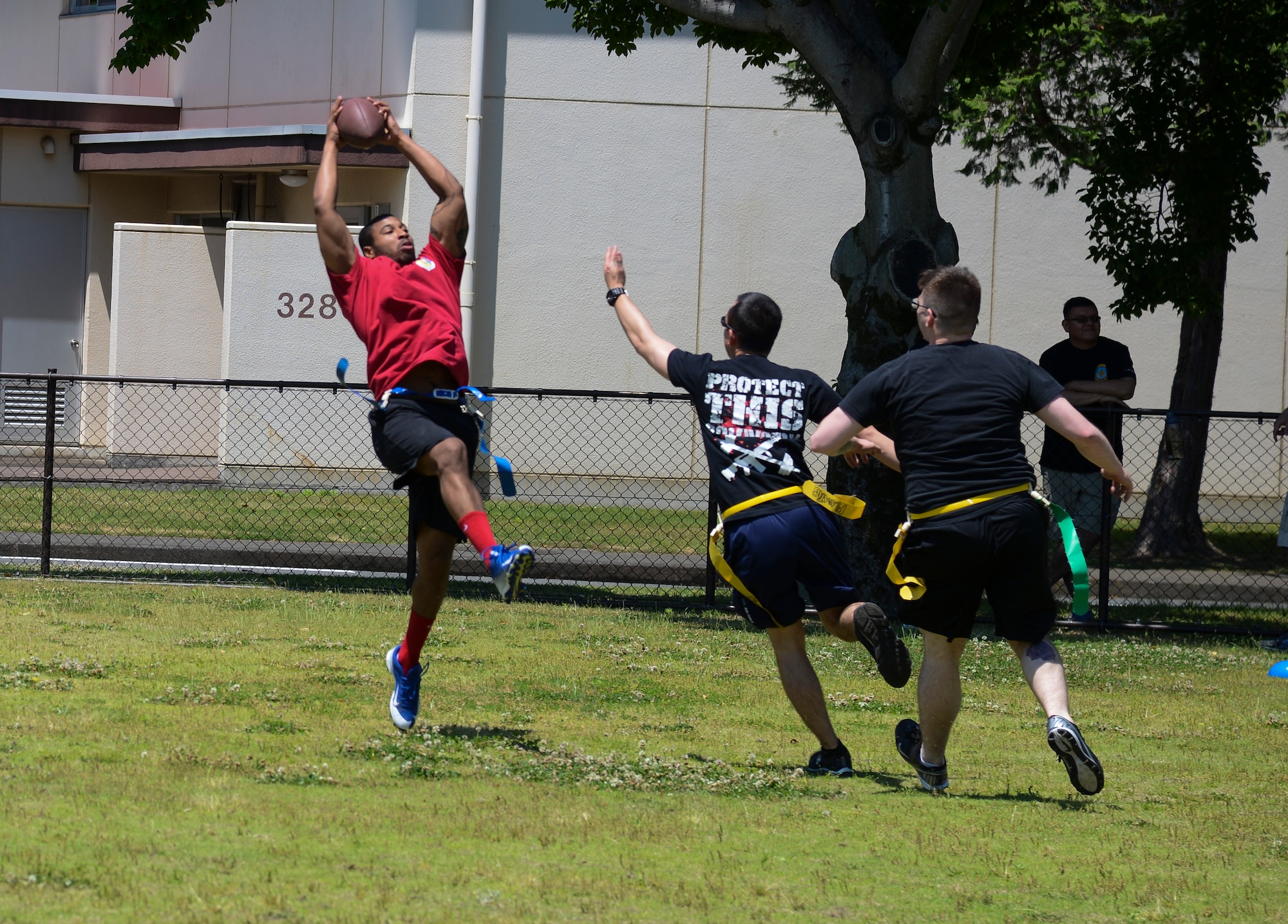 Quentin Gartrell, 374th Maintenance Operations Squadron, catches a touchdown pass against the 374 Operations Support Squadron team May 21, 2015, during the Airman Appreciation Day at Yokota Air Base, Japan. The touchdown catch gave MOS a 1-0 lead. (U.S. Air Force photo by Senior Airman David Owsianka/Released)