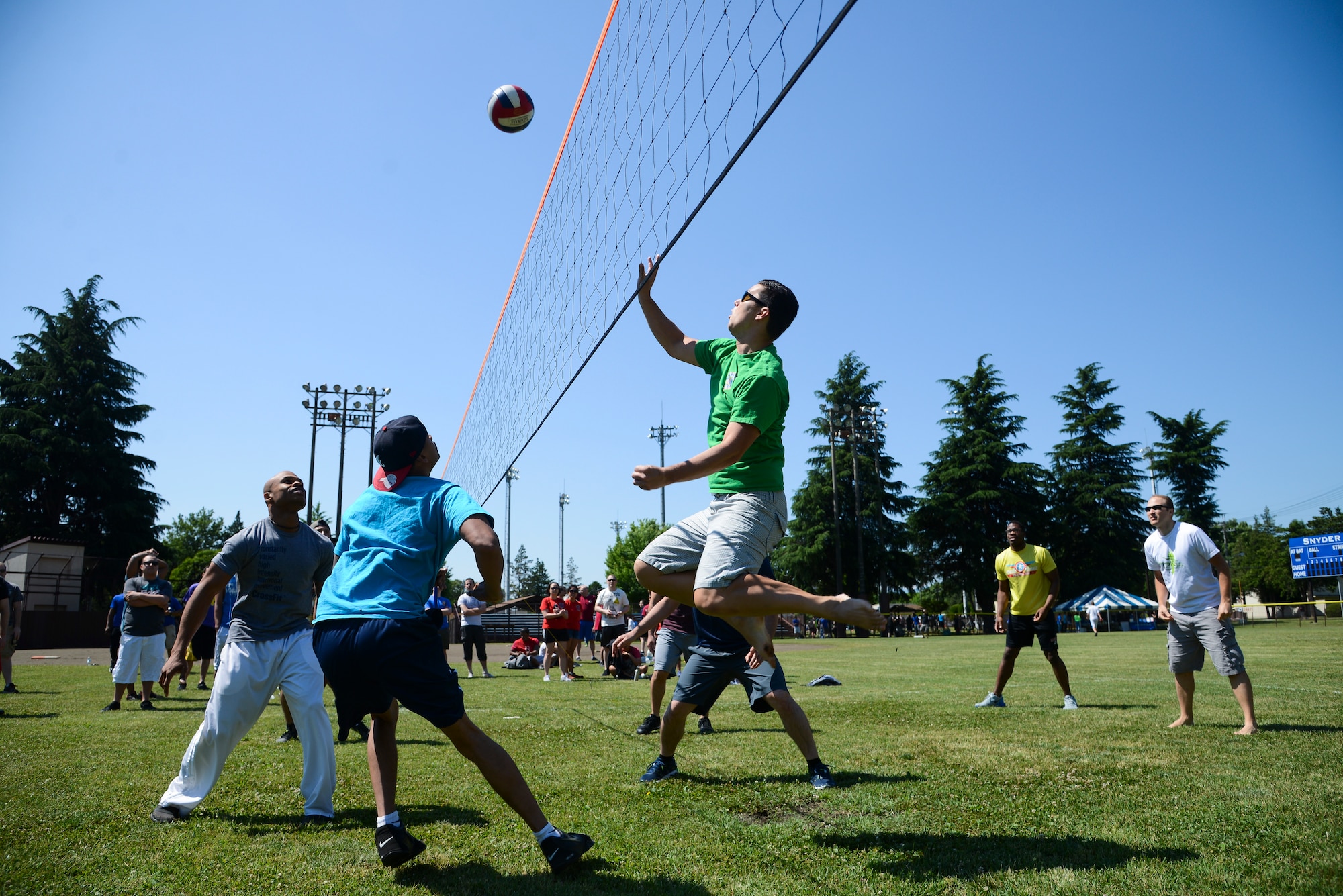 Peter Frandsen, 374th Dental Squadron, hits a ball over the net during a volleyball game against the 374th Logistic Readiness Squadron team May 21, 2015, during Airman Appreciation Day at Yokota Air Base, Japan. DS won the match 25-19. (U.S. Air Force photo by Senior Airman David Owsianka/Released)