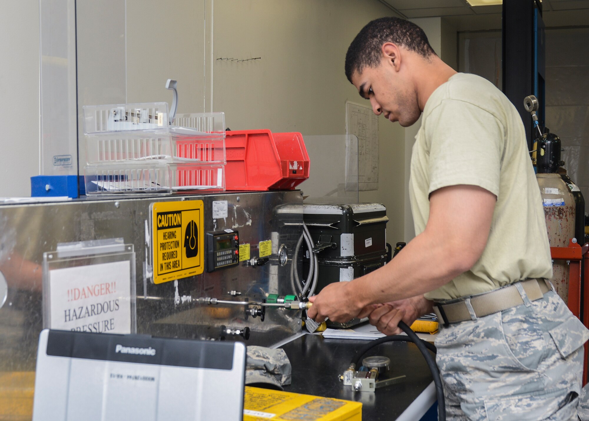 Senior Airman Joseph Fowlkes, 412th Maintenance Squadron, works on an aircraft tire inflator kit in the Precision Measurement Equipment Laboratory. (U.S. Air Force photo by Rebecca Amber)