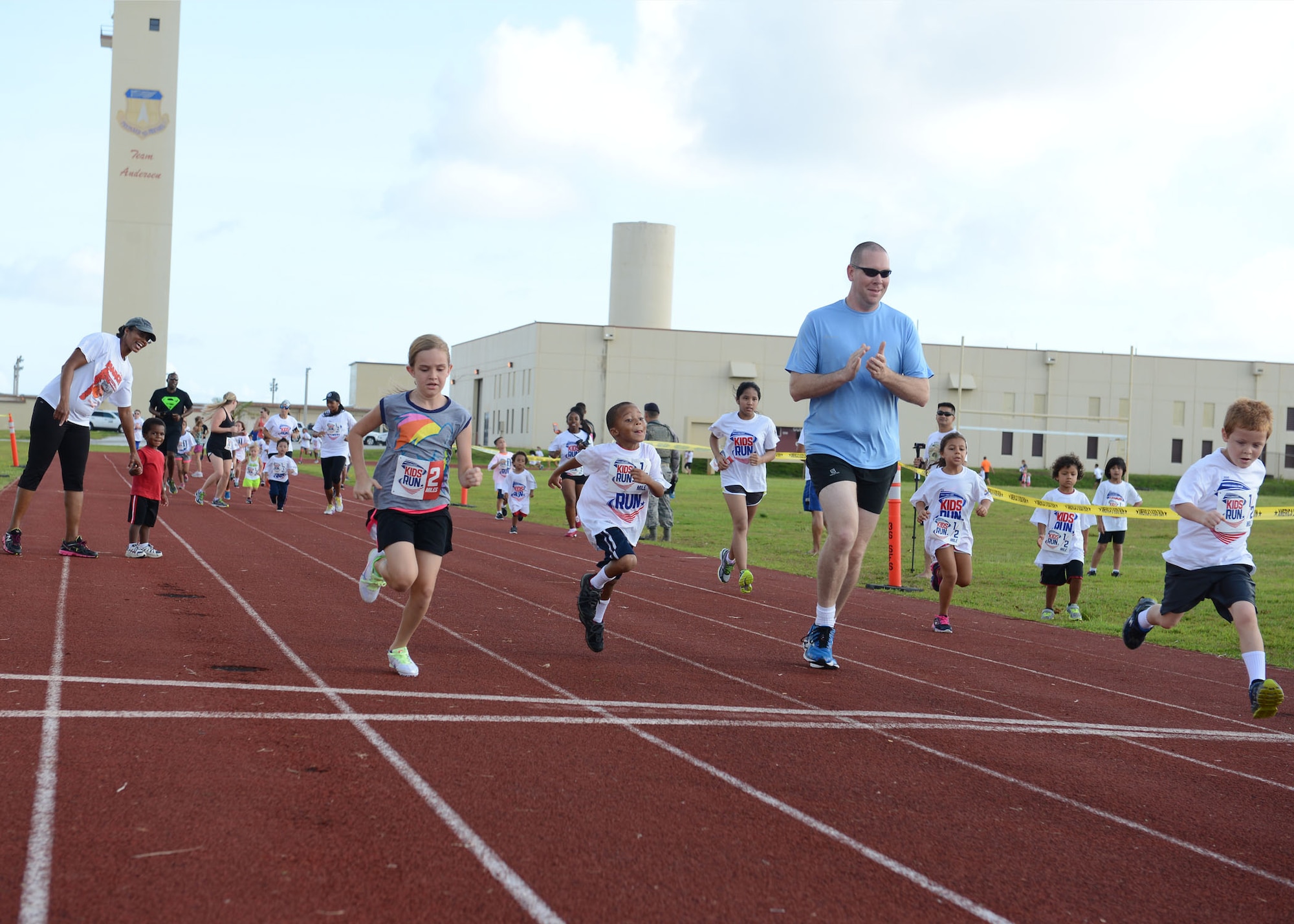 Parents and children race for the fastest time during the America’s Kids Run May 25, 2015, at Andersen Air Force Base, Guam. Depending on age, children ran anywhere from 1/2 a mile to two miles as part of Armed Forces Day activities. (U.S. Air Force photo by Airman 1st Class Joshua Smoot/Released)