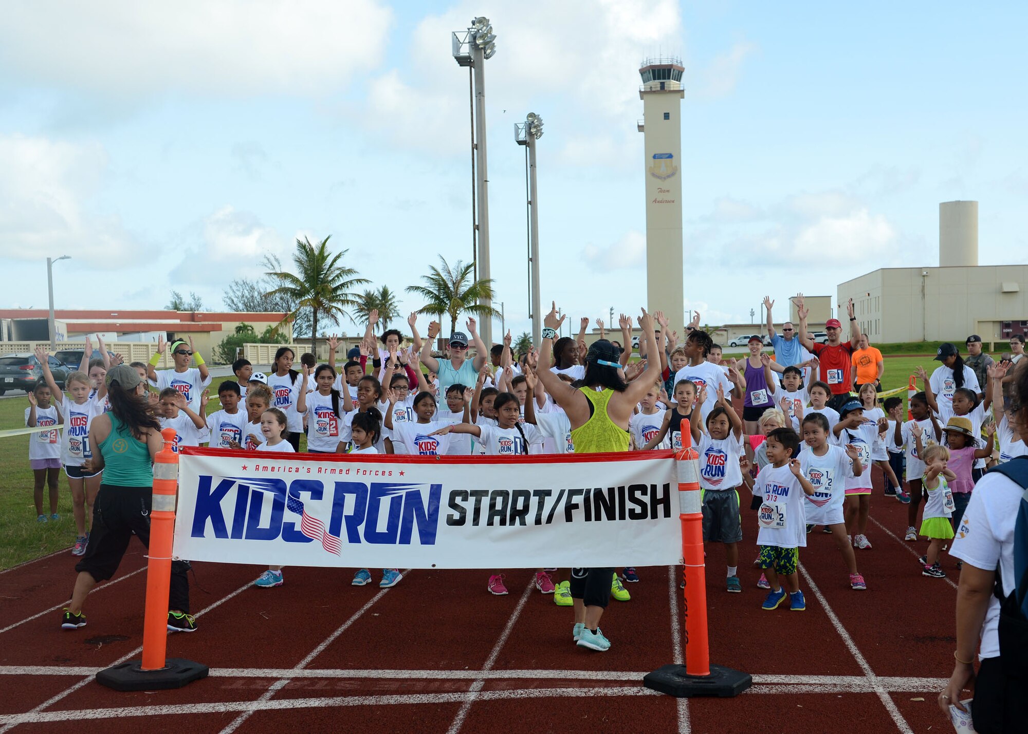Children perform exercises to warm-up before the America’s Kids Run May 25, 2015, at Andersen Air Force Base, Guam.  As part of Armed Forces Day activities in May each year, family members participate in the America's Kids Run. (U.S. Air Force photo by Airman 1st Class Joshua Smoot/Released)