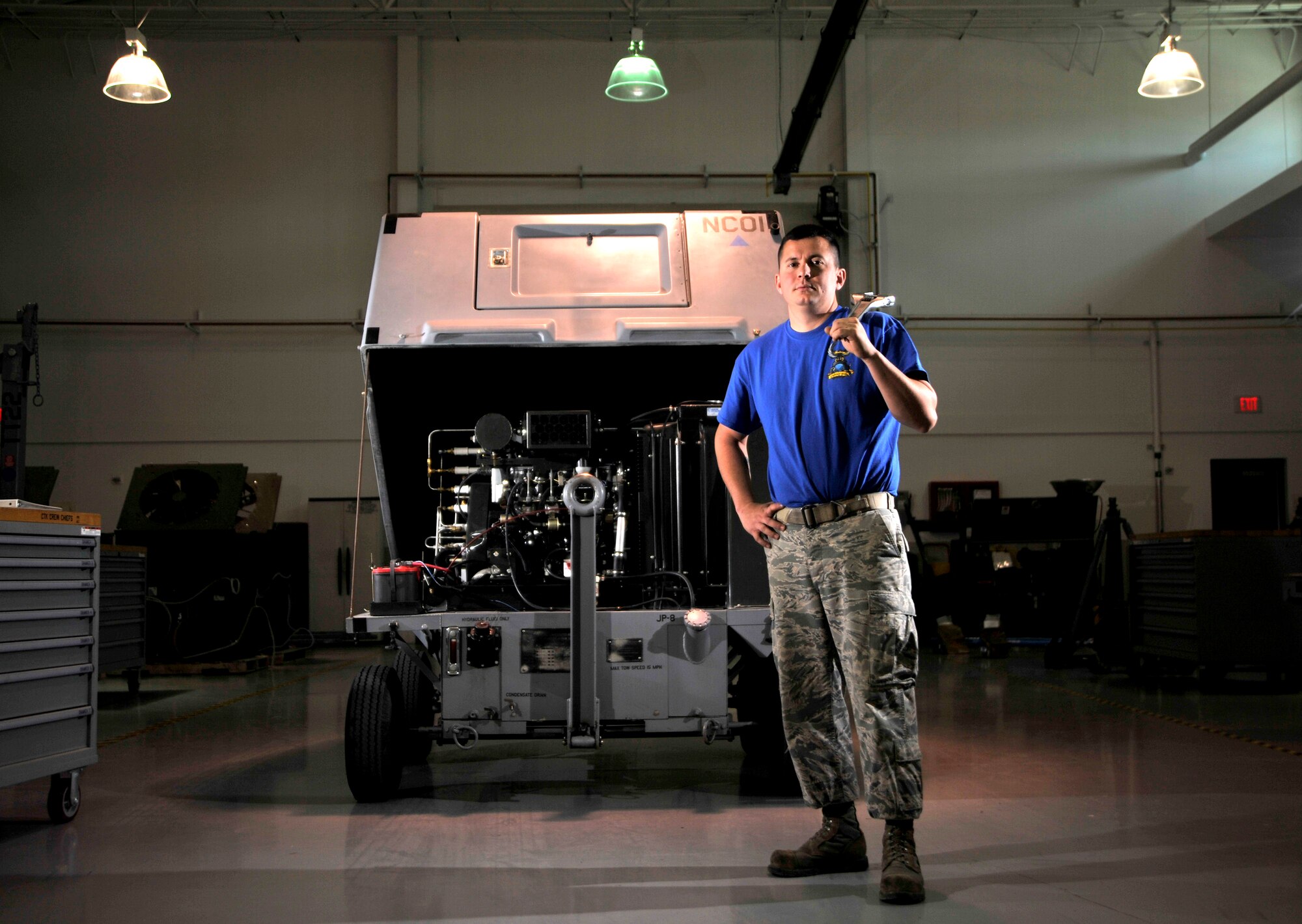 Tech Sgt. Kasey Hollinger, 432nd Maintenance Squadron aerospace ground equipment craftsman, poses next to self generating nitrogen cart May 19, 2015 at Creech Air Force Base, Nevada. The self-generating nitrogen cart is used to separate nitrogen from the oxygen in the air and compresses it to be used to inflate age equipment and aircraft tires. (U.S. Air Force photo by Senior Airman Adarius Petty/Released)