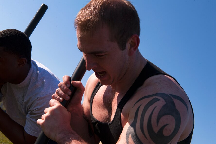 Senior Airman Joseph Rodland, 5th Security Forces Squadron defender, along with his team, Charlie Flight, push a weighted sled in the last portion of the Security Forces Survivors Challenge on Minot Air Force Base, N.D., May 20, 2015. The Security Forces Survivors Challenge was an event held for Police Week, which honors fallen police officers in the line of duty. (U.S. Air Force photo/Airman 1st Class Christian Sullivan)