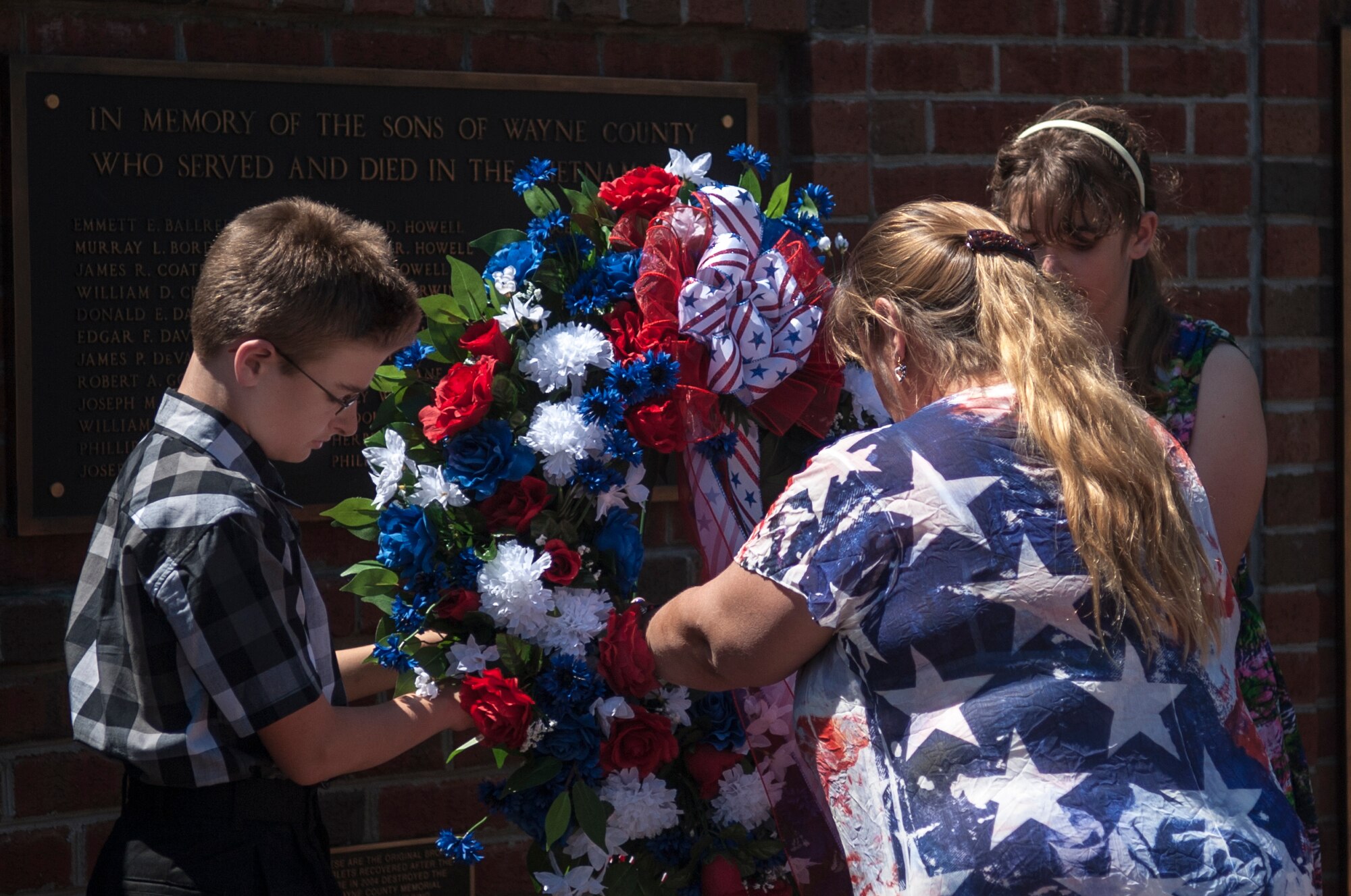 Melissa Watkins (right), Gold Star spouse, and her two children place the wreath during a Memorial Day ceremony, May 25, 2015, in Goldsboro, North Carolina. Watkins’ late husband, Lt. Col. William Watkins III, was killed in action, April 7, 2003, in support of Operation Iraqi Freedom. (U.S. Air Force photo/Airman Shawna L. Keyes)