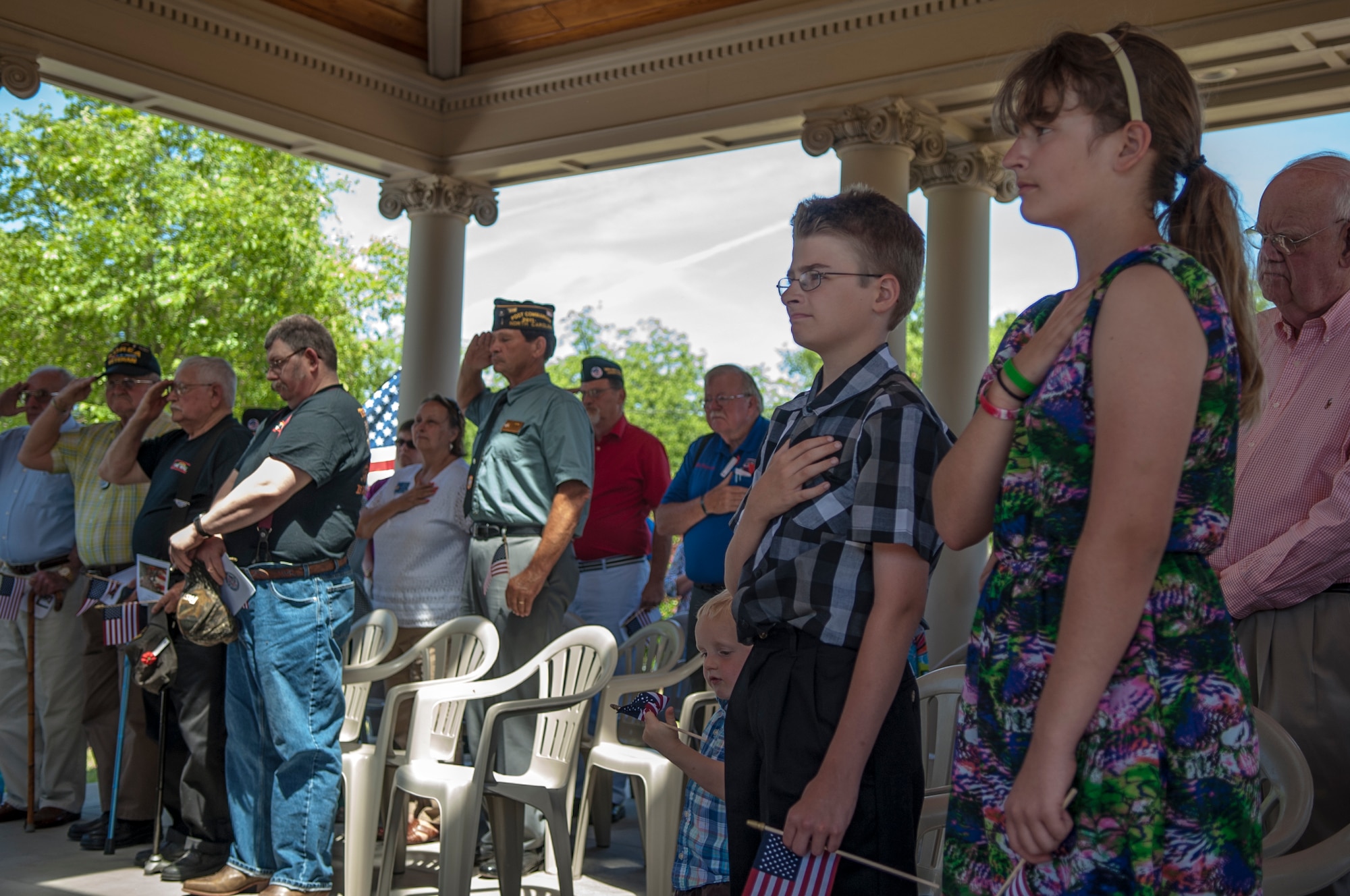 Members of the Watkins Gold Star family  pay respect during the National Anthem at a  Memorial Day ceremony, May 25, 2015, in Goldsboro, North Carolina. Melissa Watkins and her children presented a wreath during the ceremony. (U.S. Air Force photo/Airman Shawna L. Keyes) 