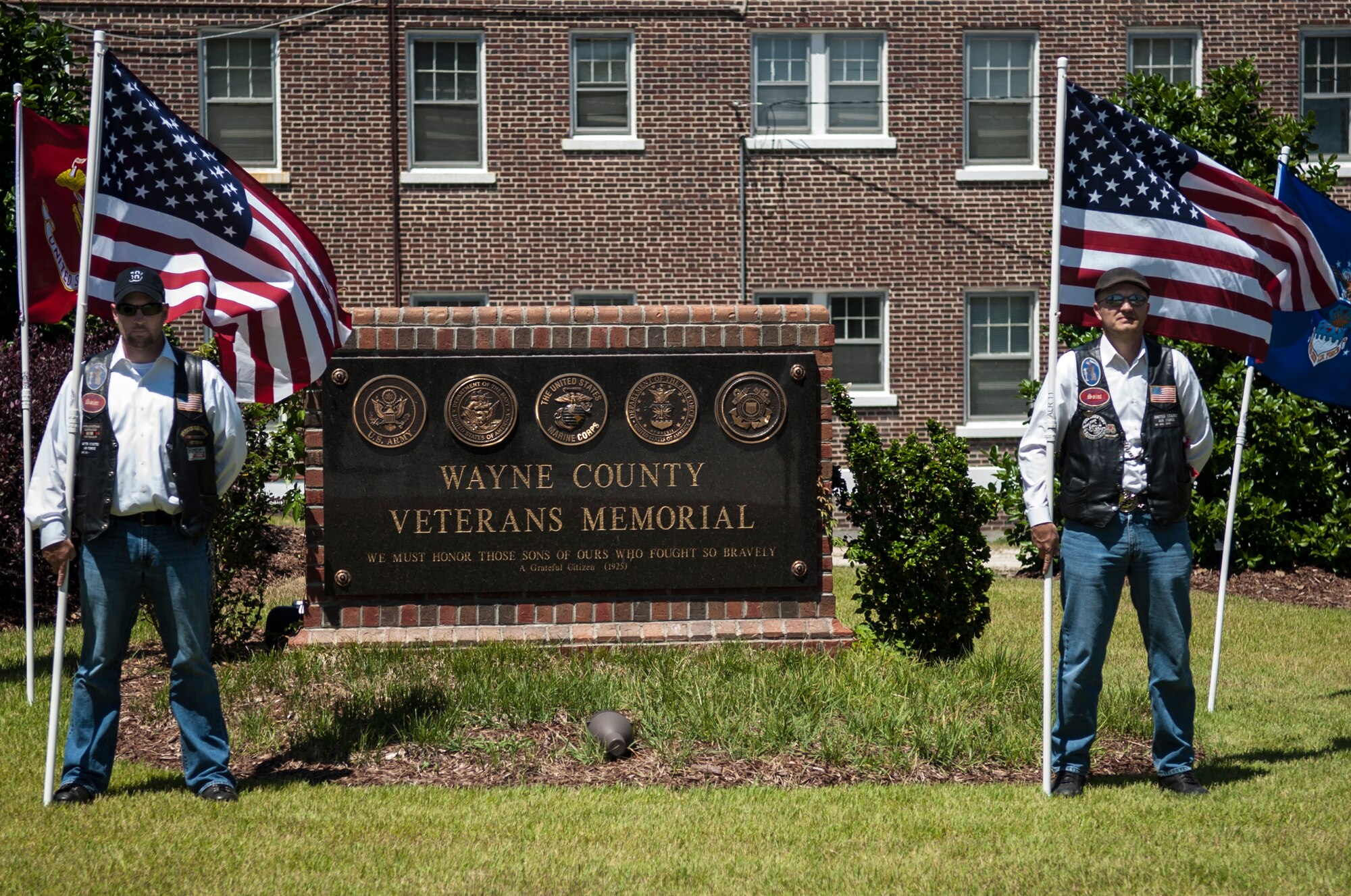 Senior Master Sgt. Jamie Farnell (left), 4th Aircraft Maintenance Squadron production superintendent, and Chief Master Sgt. James Loper, 916th Air Refueling Wing command chief, both founding members of the Guardian Brotherhood, stand with American flags, May 25, 2015, in Goldsboro, North Carolina. The Guardian Brotherhood played a role in the city’s observance of a national moment of silence for Memorial Day. (U.S. Air Force photo/Airman Shawna L. Keyes) 