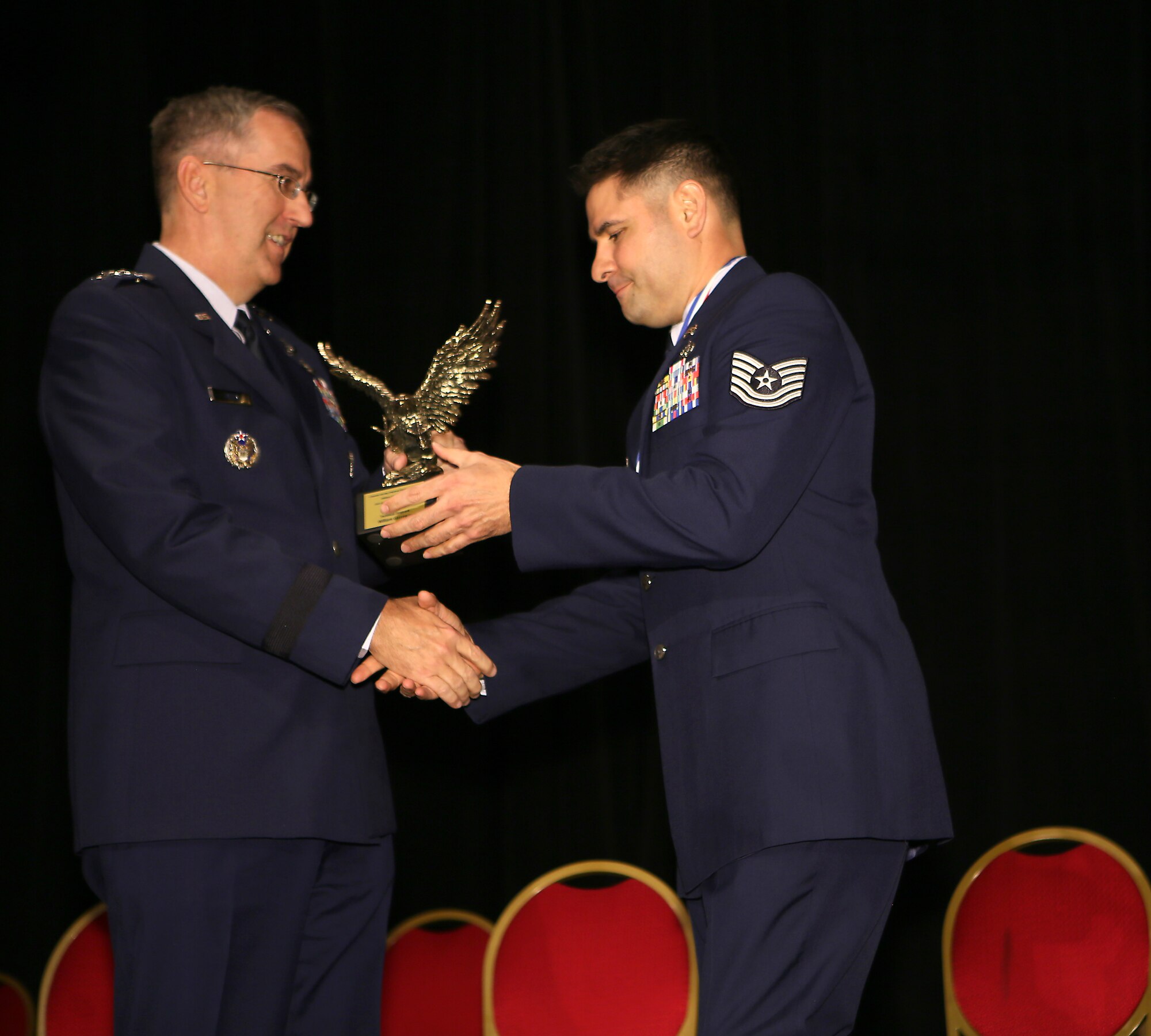 COLORADO SPRINGS, Colorado –  Gen. John Hyten, Air Force Space Command commander, presents Tech. Sgt. William Gazzaway, 21st Communications Squadron, with the 2015 Best Enlisted Personnel in the Pikes Peak Region, E5-E6 category trophy, awarded by the Colorado Springs Regional Business Alliance Military Affairs Council May 13. The honor was given during the group’s Armed Forces Week luncheon. (Photo courtesy Tom Kimmell Photography)