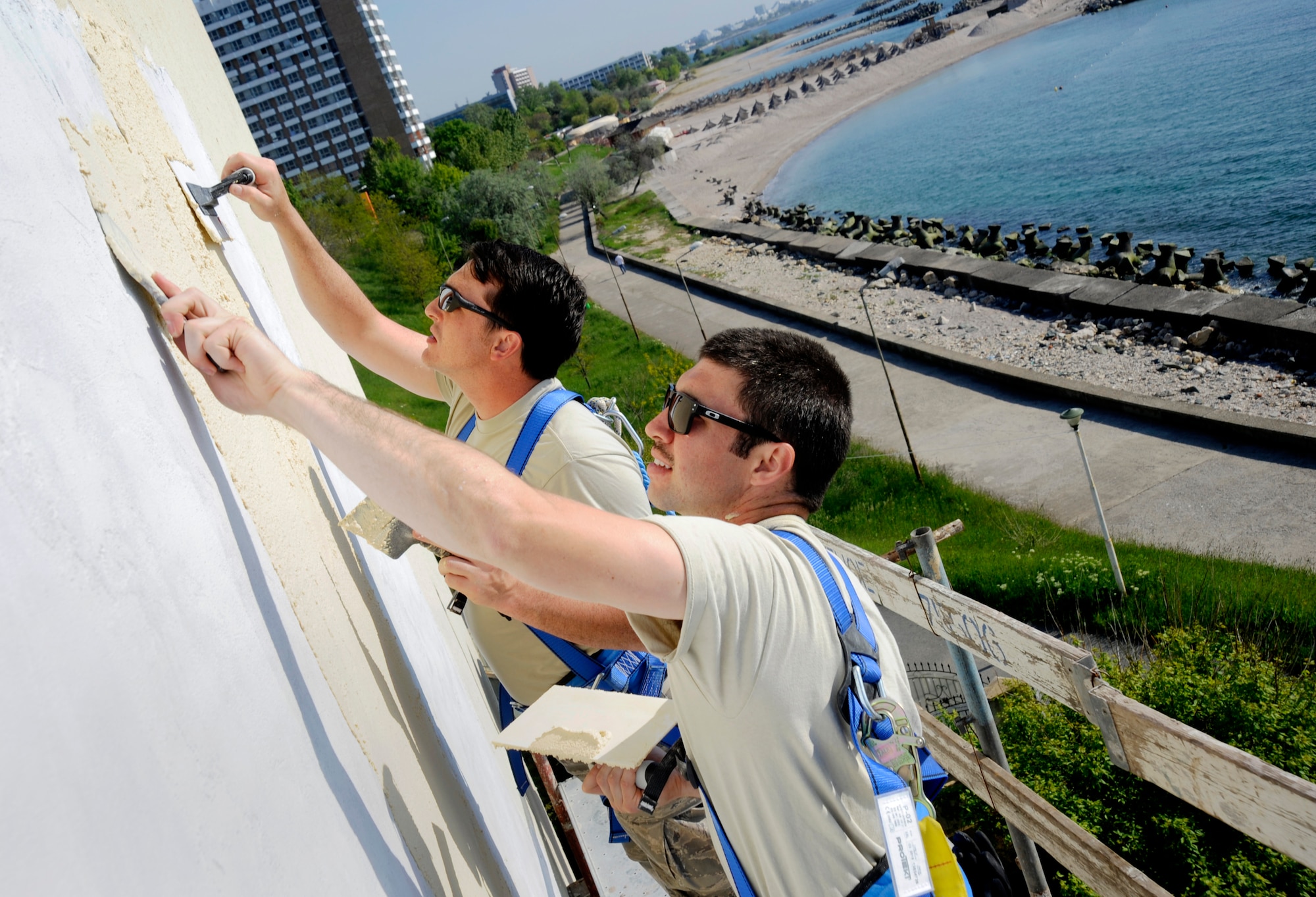 Oregon Air National Guard Tech. Sgt. Mathew Pixley and Senior Airman Daniel Beauchamp, assigned to the 142nd Fighter Wing Civil Engineer Squadron, apply stucco to the medical clinic being repaired in the city of Mangalia, Romania, May 12, 2015, as part of the U.S. European Command’s (EUCOM) Humanitarian Civic Assistance Program (HCA). The EUCOM HCA program is designed to improve the host nation's critical infrastructure and the underlying living conditions of the civilian populace. (U.S. Air National Guard photo by Tech. Sgt. John Hughel, 142nd Fighter Wing Public Affairs/Released)