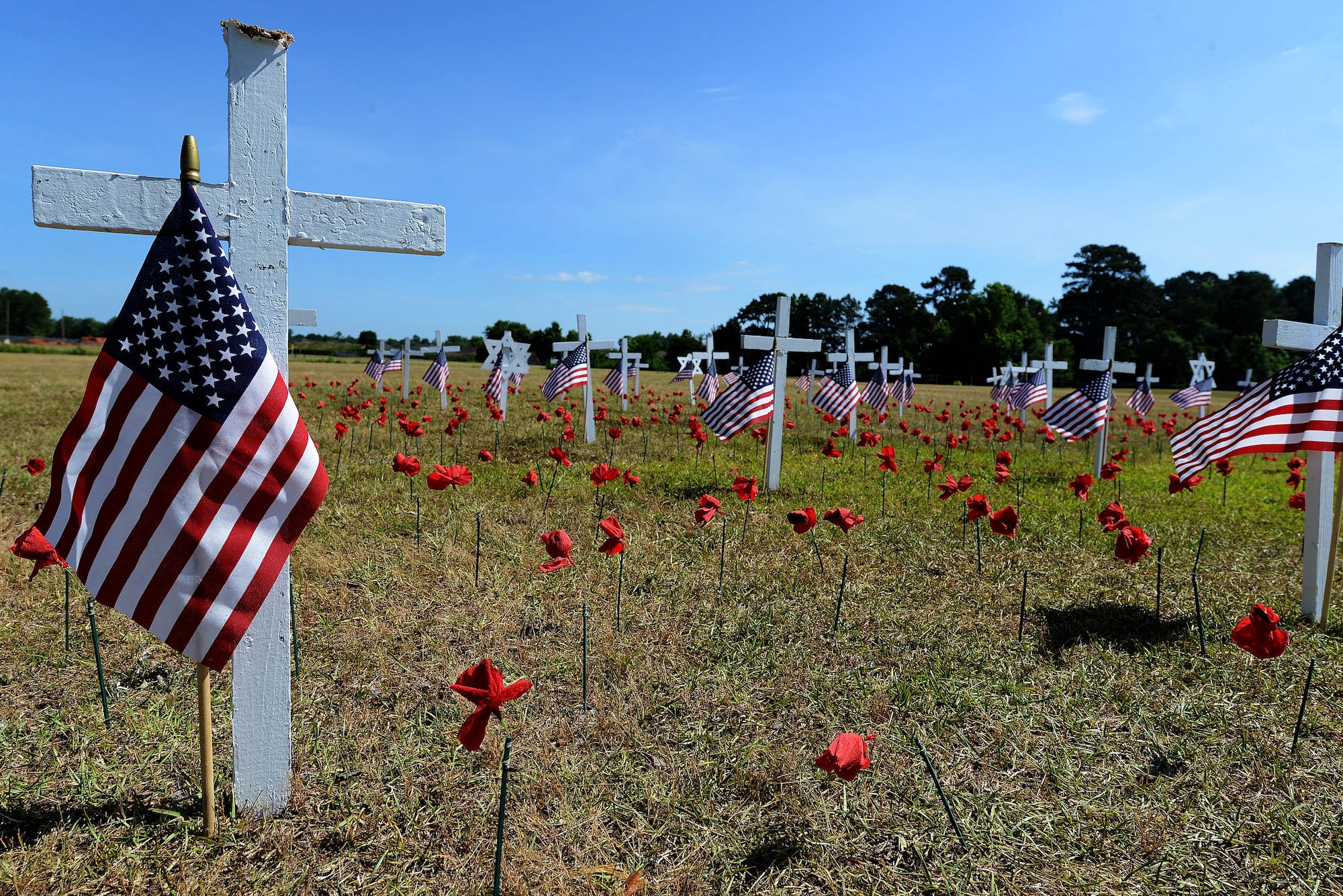 Rows of crosses with American flags where displayed during a Memorial Day ceremony at the Mabry Memorial in Sumter, South Carolina, May 25, 2015. The crosses represented those who lost their lives defending the United States. (U.S. Air Force photo by Senior Airman Diana M. Cossaboom/Released)