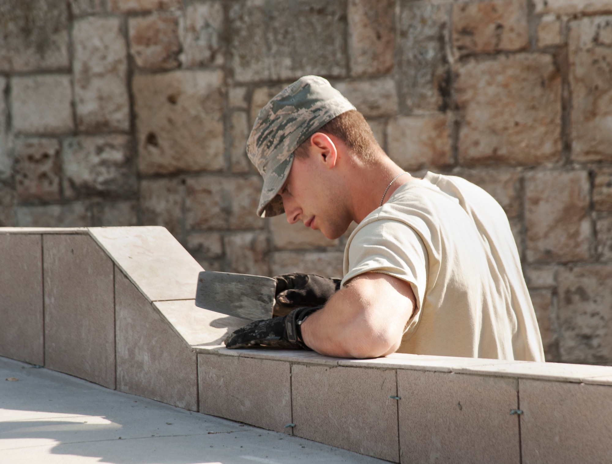 Oregon Air National Guard Airman 1st Class Andrew Altman, assigned to the 142nd Fighter Wing Civil Engineer Squadron, prepares the new tile surface to the wheelchair ramp at the Pavilion C medical facility in the city of Mangalia, Romania, May 19, 2015 as part of the U.S. European Command’s (EUCOM) Humanitarian Civic Assistance Program (HCA). The EUCOM HCA program is designed to improve the host nation's critical infrastructure and the underlying living conditions of the civilian populace. (U.S. Air National Guard photo by Tech. Sgt. John Hughel, 142nd Fighter Wing Public Affairs/Released)