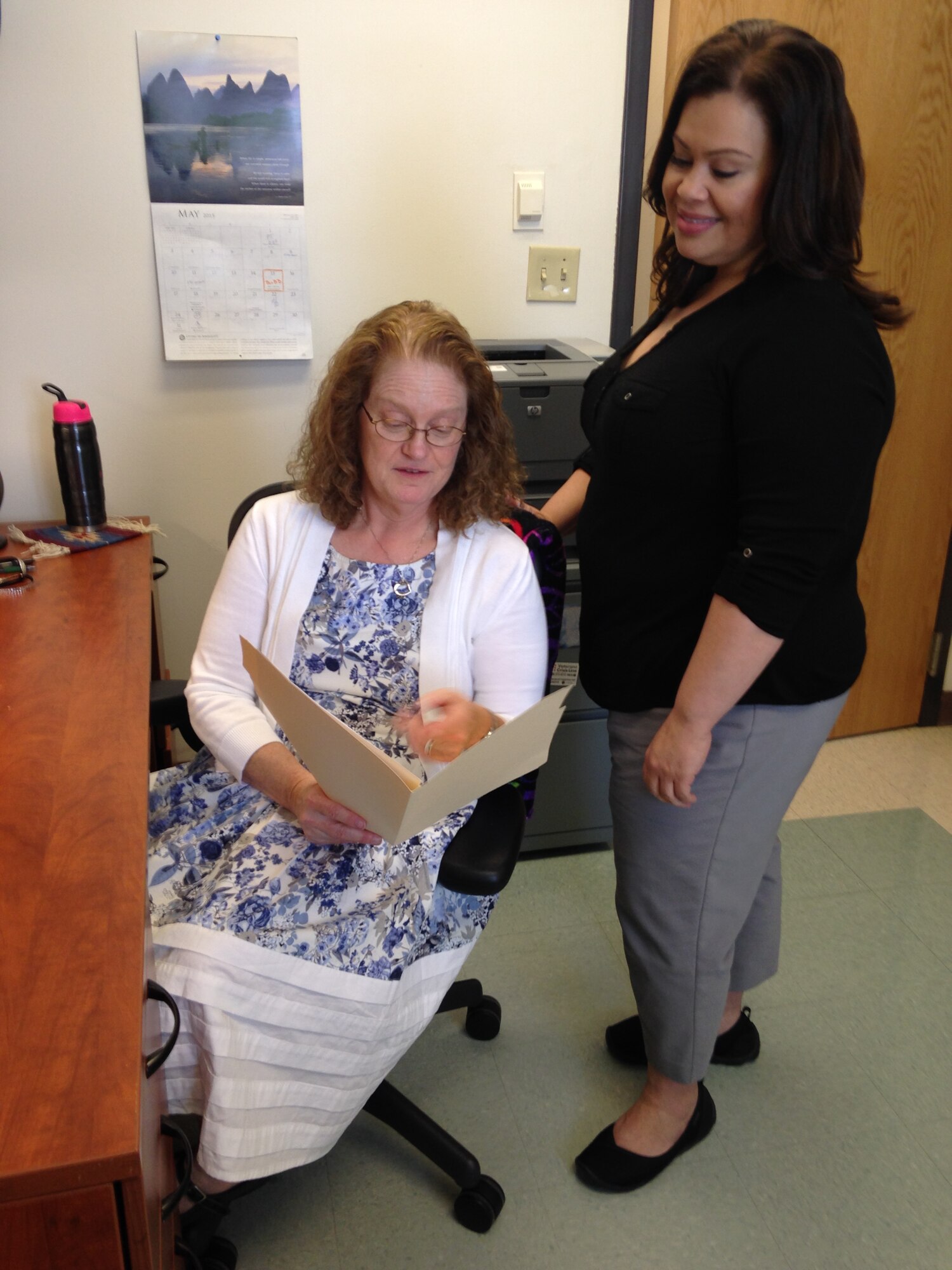 Dr. Leanna Manuel, clinical psychologist, and Michelle Aragon, registered nurse, look over a patient's chart.  The duo manage the 377th Medical Group's Behavioral Health Optimization Program. The program's purpose is to help people change habits, emotions or behaviors that are interfering with the quality of daily life.  It also offers assistance to patients of the Family Medicine Clinic manage new prescription medications. (Photo by Kendahl Johnson)