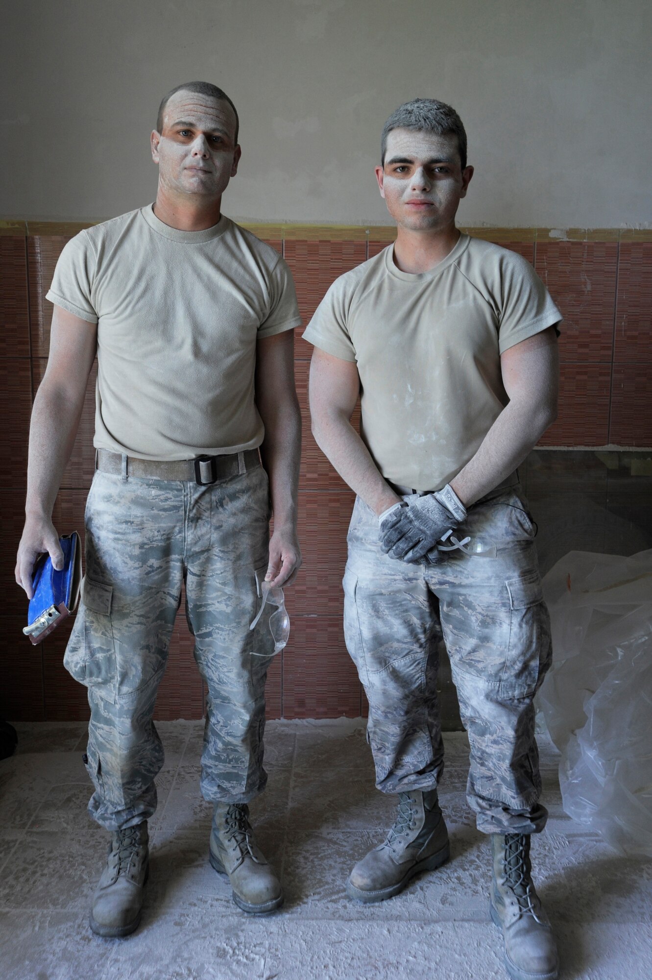 Oregon Air National Guardsmen Senior Airmen Daniel Hagemier, left, and Dustin Sevilla, right, both assigned to the 142nd Fighter Wing Civil Engineer Sqauadron, pause briefly for a photograph together after sanding plaster in a clinic treatment room at a medical being repaired in the city of Mangalia, Romania, May 13, 2015, as part of the U.S. European Command’s (EUCOM) Humanitarian Civic Assistance Program (HCA). The EUCOM HCA program is designed to improve the host nation's critical infrastructure and the underlying living conditions of the civilian populace. (U.S. Air National Guard photo by Tech. Sgt. John Hughel, 142nd Fighter Wing Public Affairs/Released)