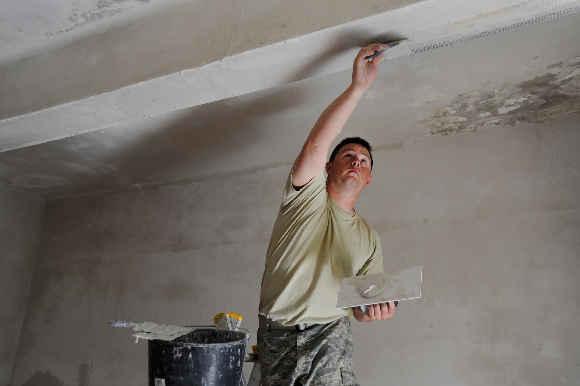 Oregon Air National Guard Tech. Sgt. Charles Jedda, assigned to the 142nd Fighter Wing Civil Engineer Squadron applies plaster to upgrade and repair water damage to a local health clinic in the city of Mangalia, Romania, May 11, 2015, as part of the U.S. European Command’s (EUCOM) Humanitarian Civic Assistance Program (HCA). The EUCOM HCA program is designed to improve the host nation's critical infrastructure and the underlying living conditions of the civilian populace. (U.S. Air National Guard photo by Tech. Sgt. John Hughel, 142nd Fighter Wing Public Affairs/Released)