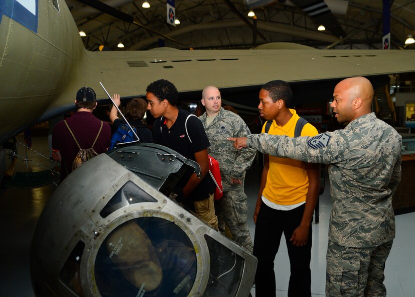 Master Sgt. Jamie Beard, 436th Maintenance Group first sergeant, shows students from Milford High School a B-17 Flying Fortress May 21, 2015, at the Air Mobility Command Museum on Dover Air Force Base, Del. Beard is a mentor for the Communities In Schools program that helps students connect the importance of education and career opportunities. (U.S. Air Force photo/Airman 1st Class William Johnson)