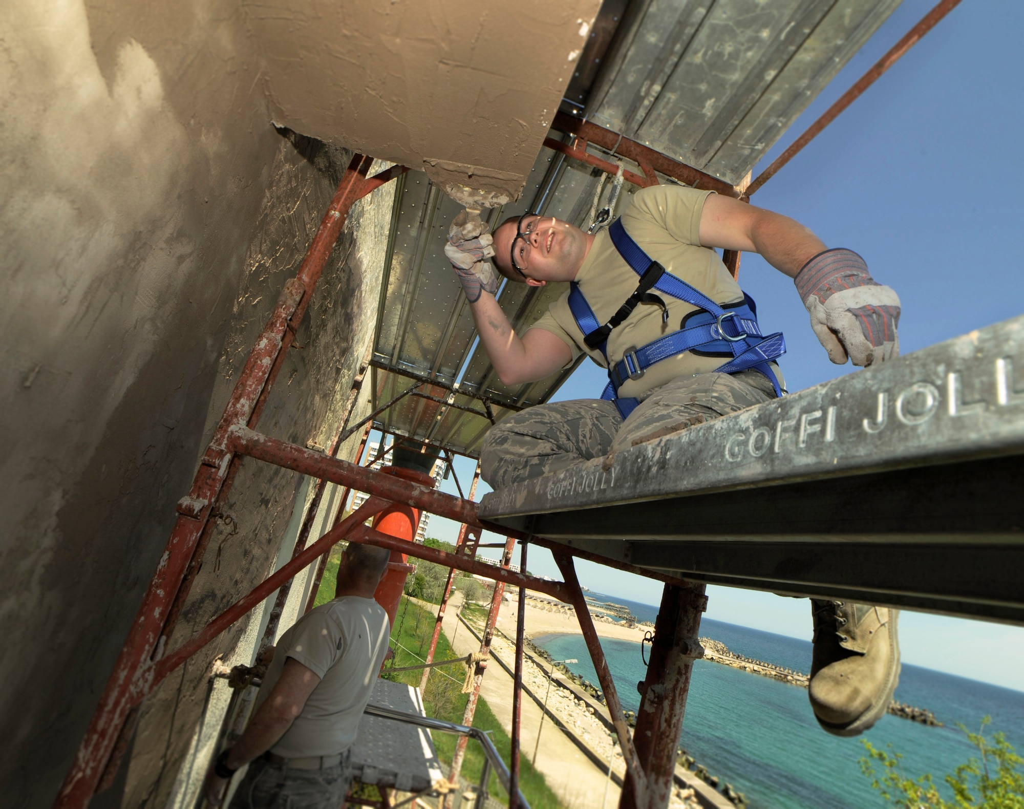 Oregon Air National Guard Tech Sgt. Adrian Tate, assigned to the 142nd Fighter Wing Civil Engineer Squadron, repairs water damage to the exterior of a medical facility in the city of Mangalia, Romania, May 8, 2015 as part of the U.S. European Command’s (EUCOM) Humanitarian Civic Assistance Program (HCA). The EUCOM HCA program is designed to improve the host nation's critical infrastructure and the underlying living conditions of the civilian populace. (U.S. Air National Guard photo by Tech Sgt. John Hughel, 142nd Fighter Wing Public Affairs/Released)