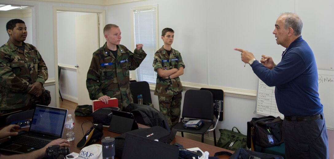 Rick Micker, right, Congressional Squadron member, Civil Air Patrol, gives a pre-flight lesson to Andrews Composite Squadron cadets for their orientation flight at Joint Base Andrews, Md., May 23, 2015.  During the pre-flight inspection, Micker taught cadets how to check the weight and balance of the aircraft. (U.S. Air Force photo/Airman 1st Class Ryan J. Sonnier)