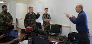 Rick Micker, right, Congressional Squadron member, Civil Air Patrol, gives a pre-flight lesson to Andrews Composite Squadron cadets for their orientation flight at Joint Base Andrews, Md., May 23, 2015.  During the pre-flight inspection, Micker taught cadets how to check the weight and balance of the aircraft. (U.S. Air Force photo/Airman 1st Class Ryan J. Sonnier)