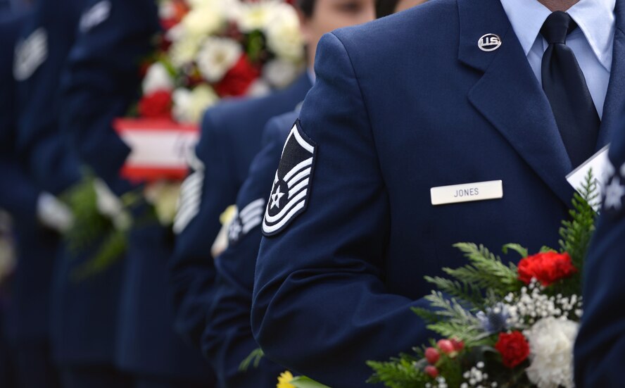 RAF Mildenhall Airmen standby with respective wreaths to lay during the annual Memorial Day Ceremony May 25, 2015, at the Cambridge American Cemetery and Memorial in Cambridge, England.  The annual ceremony is held in remembrance of service members who lost their lives during World War II (U.S. Air Force photo by Senior Airman Christine Halan/Released)
