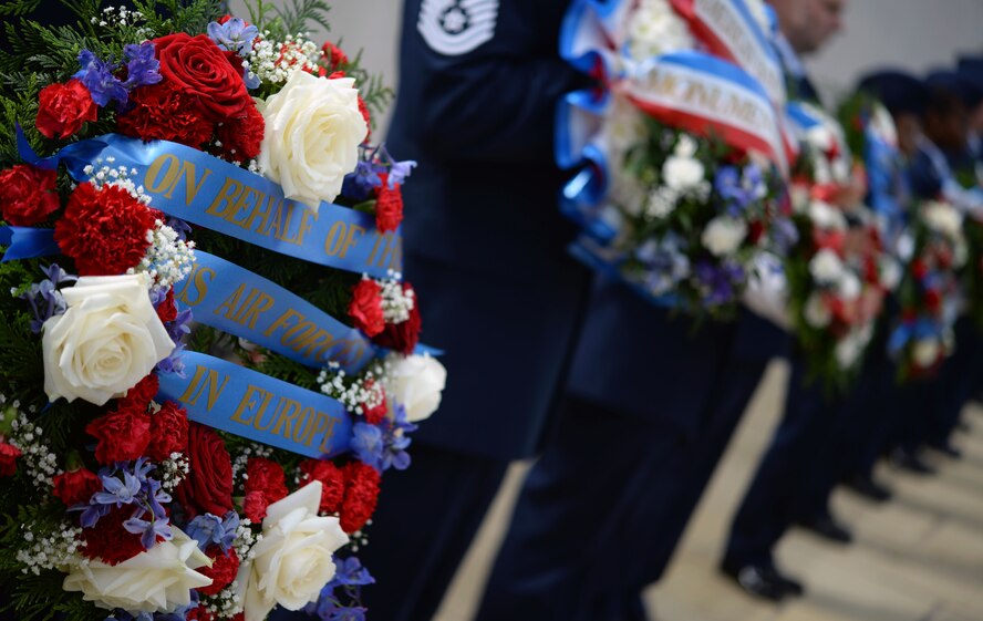 RAF Mildenhall Airmen hold wreaths at the Tablets of the Missing during the Memorial Day Ceremony, May 25, 2015, at the Cambridge American Cemetery and Memorial in Cambridge, England. The annual ceremony was held in memory of more than 400,000 American World War II service members who paid the ultimate sacrifice in service to their country. (U.S. Air Force photo by Senior Airman Christine Halan/Released)