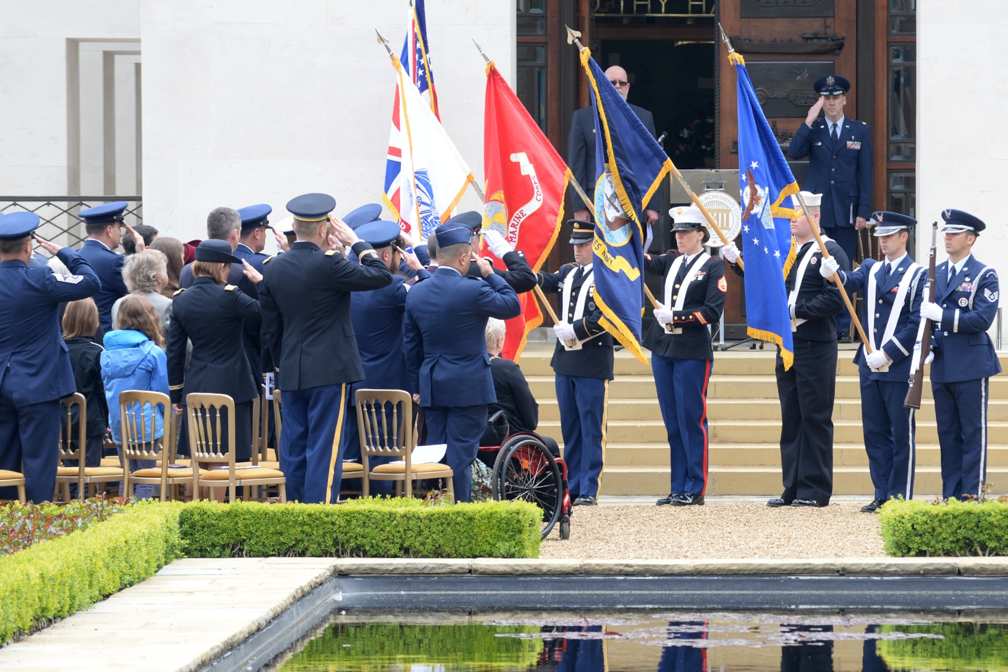 A joint service color team presents the colors during a Memorial Day observance May 25, 2015, at Cambridge American Cemetery and Memorial in Cambridge, England. The honor guard also performed a three-volley salute during the service in remembrance of fallen heroes. (U.S. Air Force photo by Senior Airman Kate Thornton/Released)