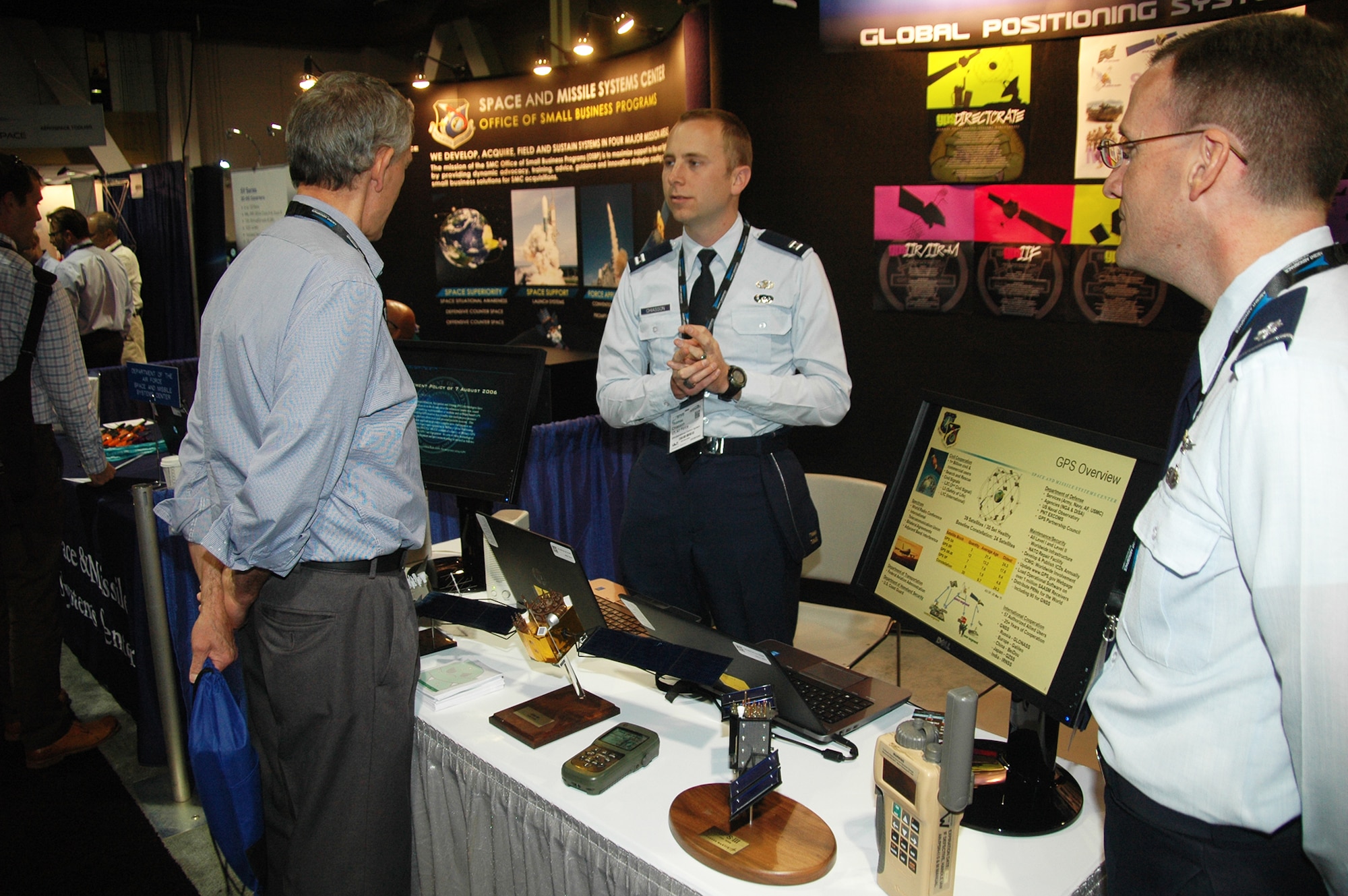 Capt. Thomas Chiasson, GPS Operational Control Systems, and Lt. Col. Jacob Freeman, GPS Deputy Chief Engineer, from the Space and Missile Systems Center at Los Angeles Air Force Base in El Segundo, Calif., talk with an attendee during the 2015 Space Tech Conference and Expo, held at the Long Beach Convention Center May 19-21. More than 3,500 registered attendees and 200 exhibitors including SMC participated in the three-day space technology event. (U.S. Air Force photo/Jim Spellman)