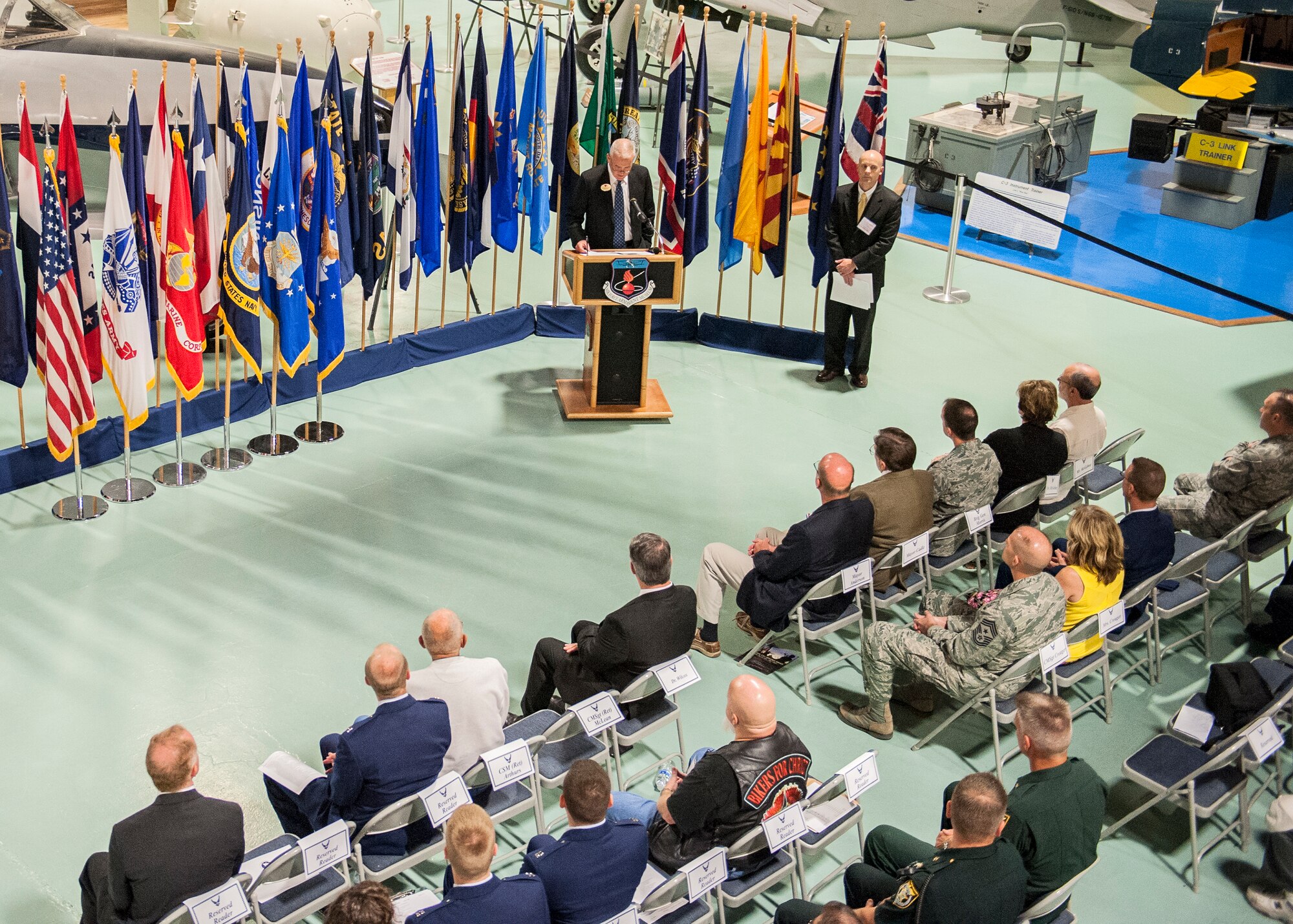 Retired Chief Master Sgt. Brooke P. McLean addresses the audience at the Roll Call Memorial Service at the Air Force Armament Museum near Eglin Air Force Base, Fla., May 22.  The ceremony paid respect to 550 fallen Florida service members who died in the service of their country during conflicts ranging from World War II to the present. The event included the posting of the colors by Eglin’s Honor Guard, the reading of a congressional letter of appreciation and the recital of each name of the fallen. (U.S. Air Force photo/Ilka Cole)
