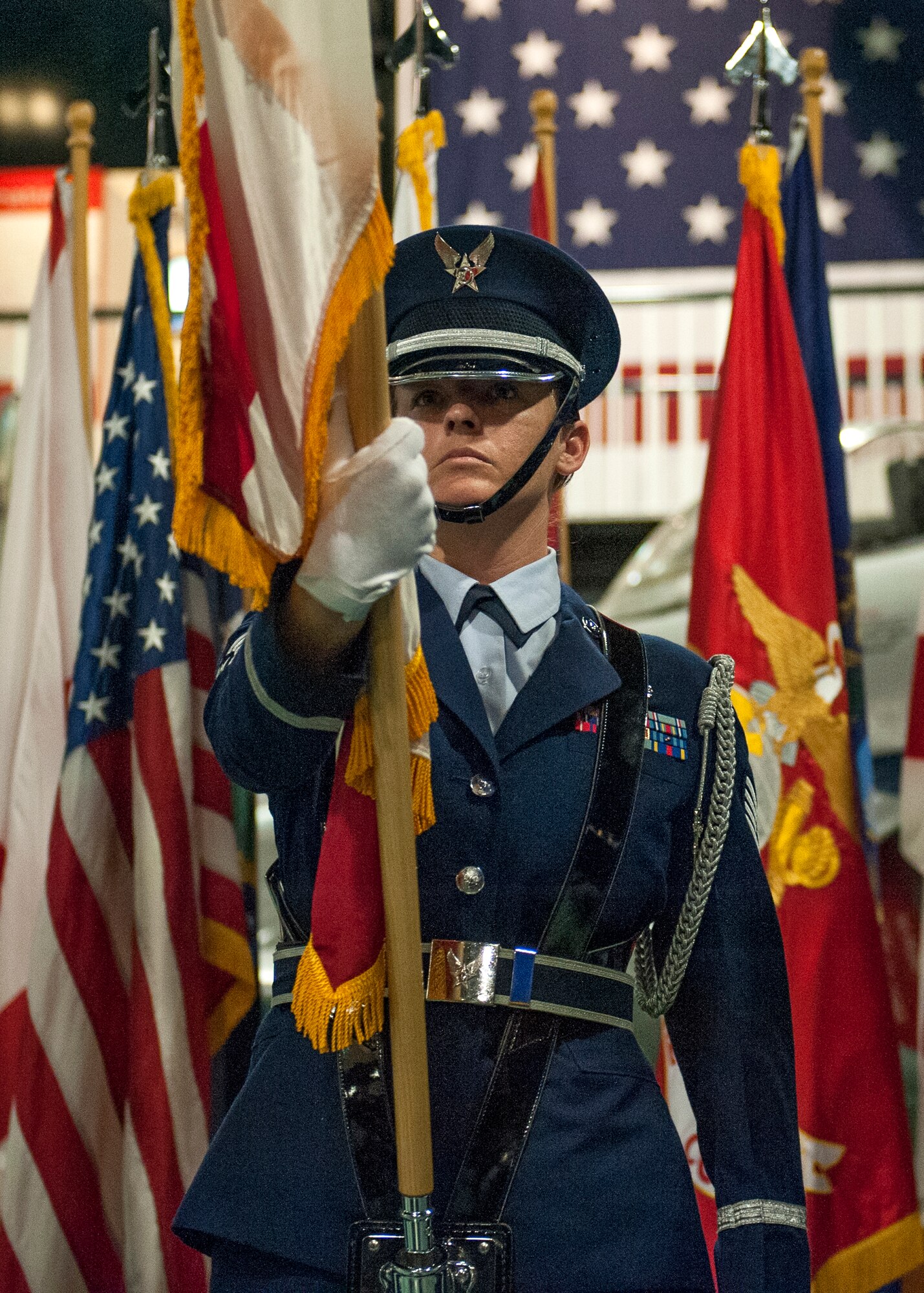 Staff Sgt. Jessica Scharmen, a member of Eglin’s Honor Guard readies the colors during the Roll Call Memorial Service at the Air Force Armament Museum near Eglin Air Force Base, Fla. May 22.  The ceremony paid respect to 550 fallen Florida service members who died in the service of their country during conflicts ranging from World War II to the present. The event included the posting of the colors by Eglin’s Honor Guard, the reading of a congressional letter of appreciation and the recital of each name of the fallen. (U.S. Air Force photo/Ilka Cole) 