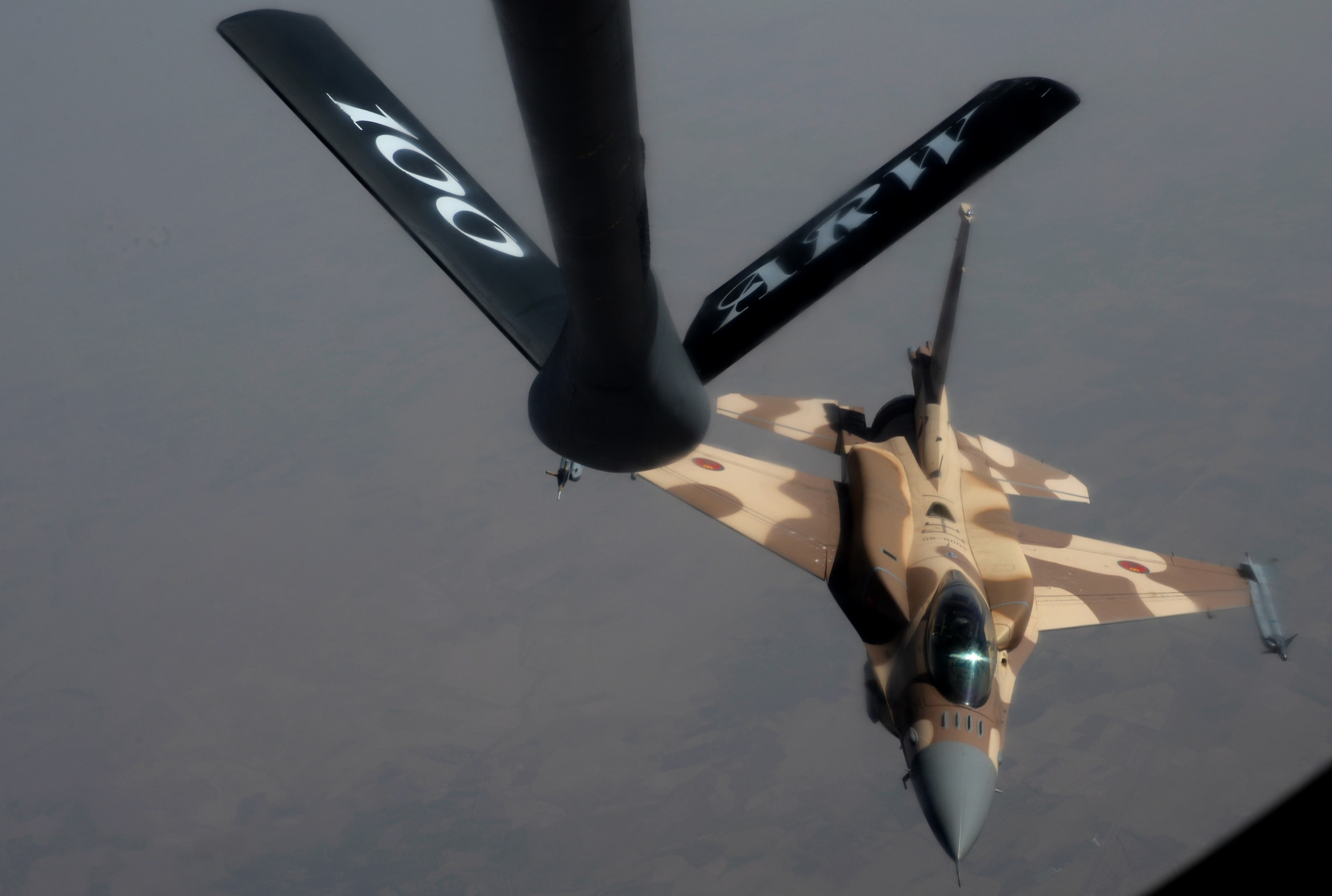 A Royal Moroccan air force F-16 Fighting Falcon releases after receiving fuel from a KC-135 Stratotanker assigned to RAF Mildenhall, England, while participating in Exercise African Lion May 18, 2015. The exercise features first-time integrated flying operations training and is the largest Department of Defense exercise in Africa (U.S. Air Force photo by Senior Airman Victoria H. Taylor/Released)