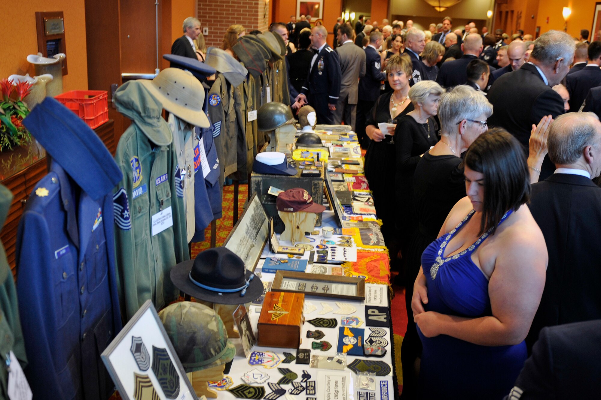 Patrons admire the U.S. Air Force historical display inside the Embassy Suites in La Vista, Nebraska for the 2015 55th Wing Birthday Ball, May 16. The birthday ball is a formal celebration recognizing the wing’s proud heritage as well as its current mission and role in the U.S. Air Force. (U.S. Air Force photo by Jeff W. Gates/Released)