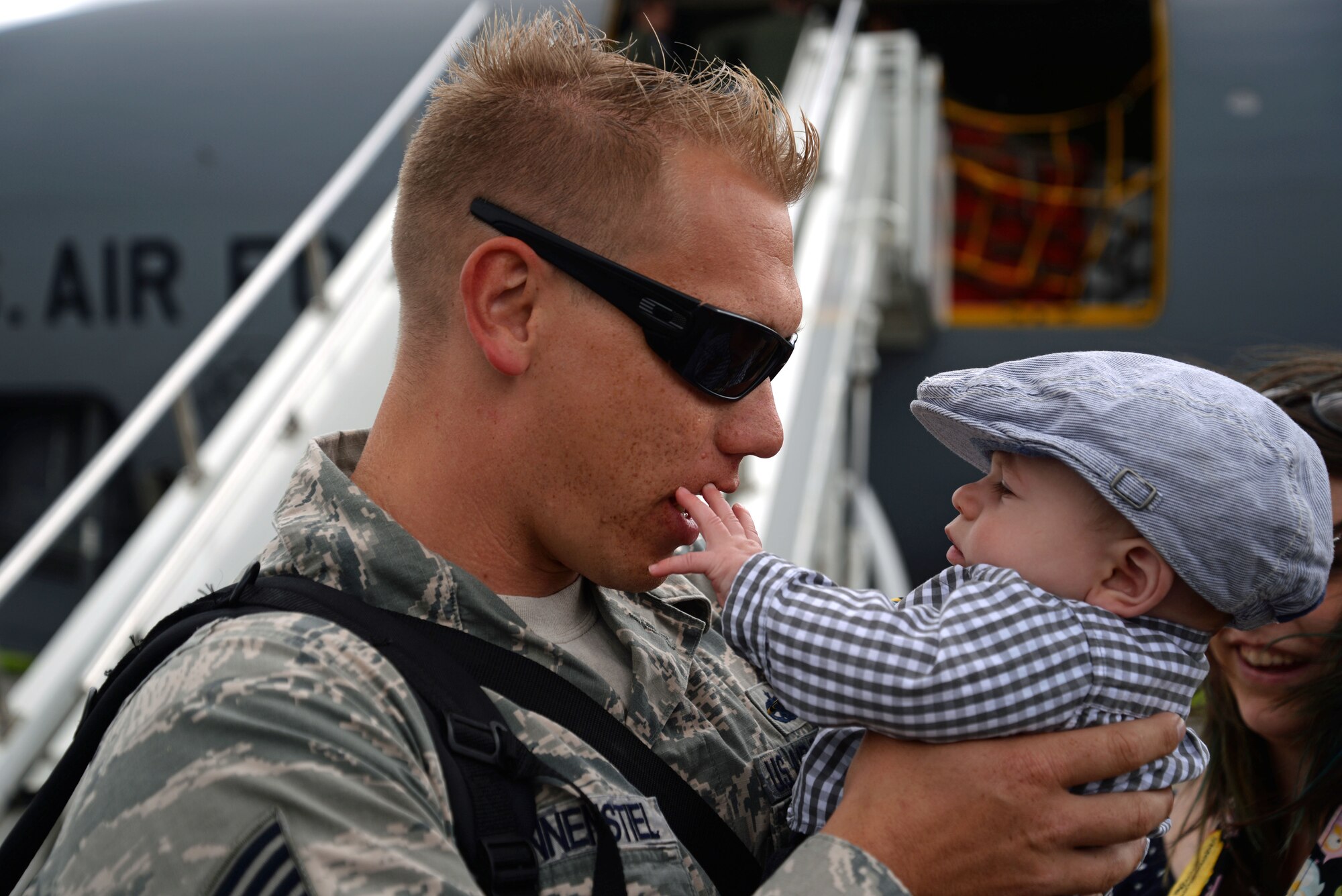 U.S. Air Force Staff Sgt. Jason Pfannenstiel, 100th Aircraft Maintenance Squadron flying crew chief from Chapin, S.C., is greeted by his son after returning from deployment May 12, 2015, at RAF Mildenhall, England. Airmen from the 100th Air Refueling Wing returned home from their deployment at Moron Air Base, Spain. The deployment to Moron was in support of French operations in Mali. (U.S. Air Force photo by Senior Airman Christine Halan/Released)