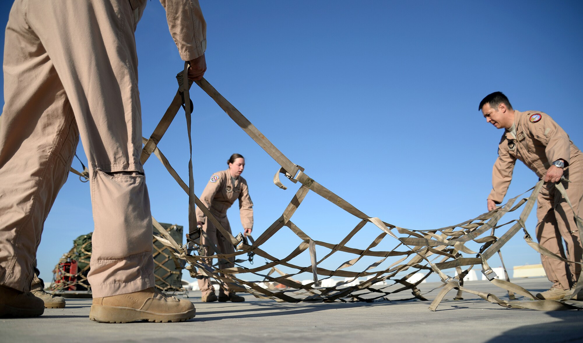 U.S. Air Force Airmen from the 351st Air Refueling Squadron prepare a cargo net for pallet building May 11, 2015, at Moron Air Base, Spain. Airmen returned home to support Operation Juniper Micron from home station, giving the 100th Air Refueling Wing more flexibility to execute the ongoing mission in Mali. Juniper Micron is the U.S. military support of French combat operations in Mali. (U.S. Air Force photo by Senior Airman Christine Halan/Released)