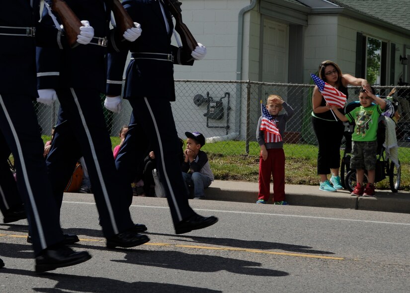 Local community members watch the U.S. Air Force Honor Guard march during the 51st Annual Memorial Day Parade in Commerce City, Colo., May 25, 2015. The Honor Guard marched in the Memorial Day parade to honor the men and women that gave their lives in service to their country. (U.S. Air Force photo by Senior Airman Preston Webb/Released)