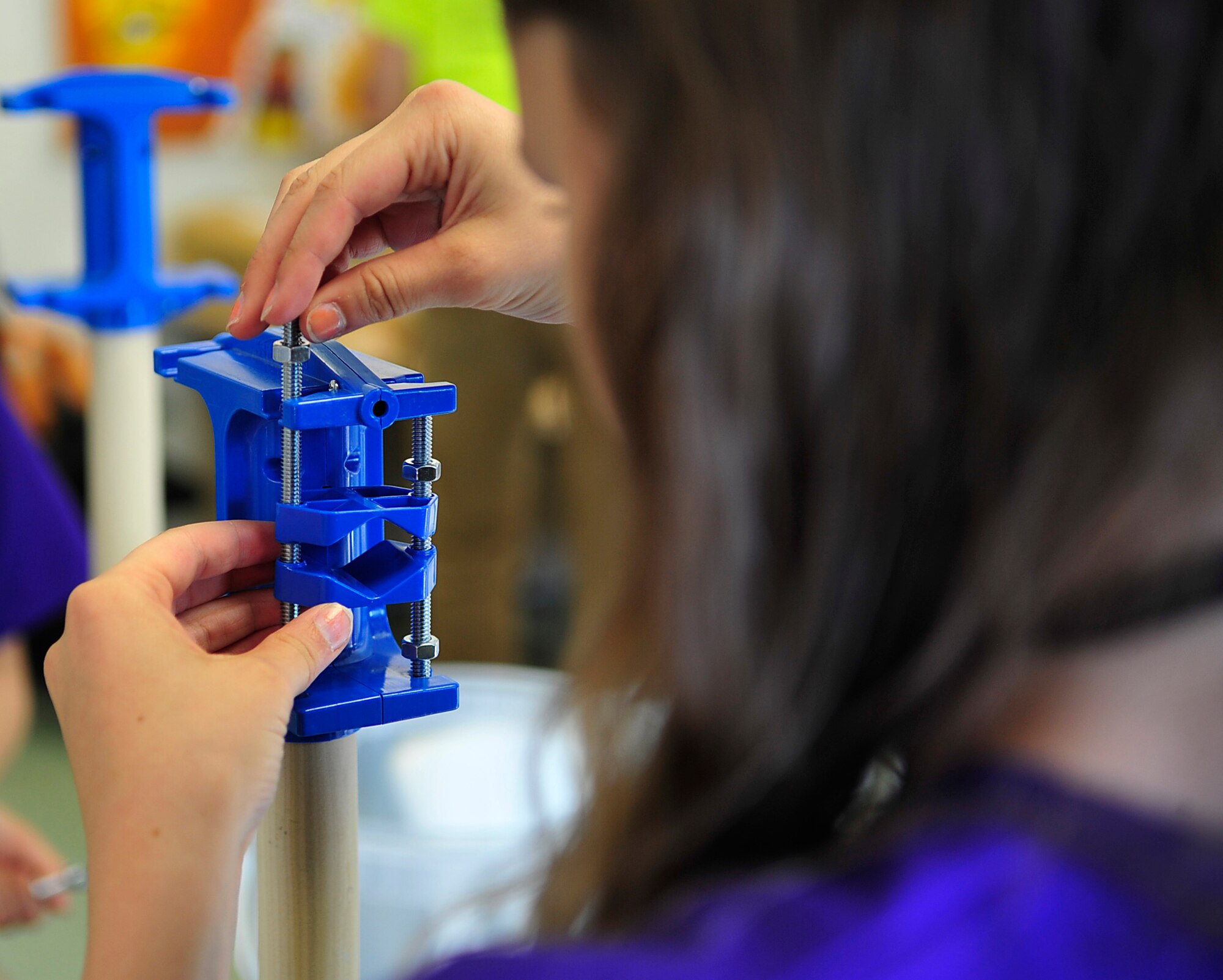 A middle school student constructs a windmill during a STEMposium challenge May 13, 2015, at Ramstein Air Base, Germany. Middle school students from all around Germany were tested on their science, technology, engineering and math skills in different challenges. (U.S. Air Force photo/Airman 1st Class Larissa Greatwood)