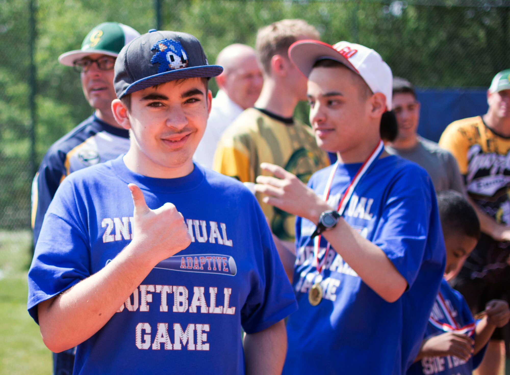 Adam Johnston gives a thumbs-up during the Ramstein High School softball field during the 2nd Annual Adaptive Softball Game on Ramstein Air Base, Germany, May 14, 2015. The event provides an opportunity for special needs children to participate in a healthy activity while receiving recognition for their efforts. (U.S. Air Force photo/Staff Sgt. Brandy Grace)