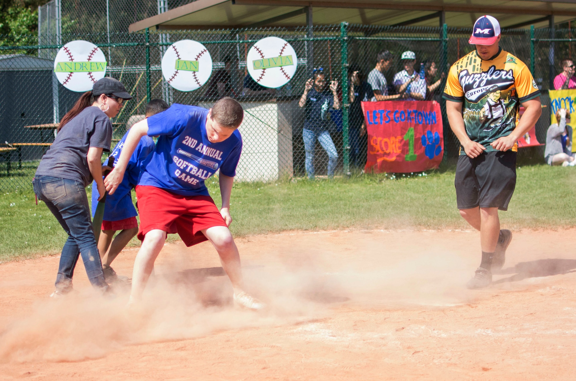 Braden Marler slides into home plate at the Ramstein High School softball field during the 2nd Annual Adaptive Softball Game on Ramstein Air Base, Germany, May 14, 2015. The event provides an opportunity for special needs children to participate in a healthy activity while receiving recognition for their efforts. (U.S. Air Force photo/Staff Sgt. Brandy Grace)