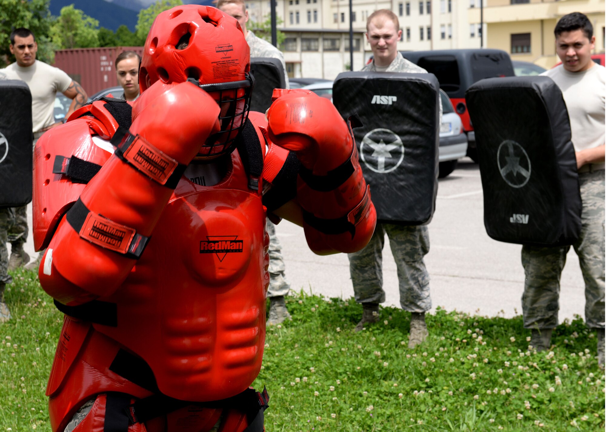 U.S. Air Force Staff Sgt. Joshua Ferguson, 31st Security Forces Squadron defender, dons the “redman” suit to train Airmen during expandable baton training and certification, May 21, 2015, at Aviano Air Base, Italy. Defenders learned tactics to use against aggressive individuals who they may encounter on the job. (U.S. Air Force photo by Airman 1st Class Cary Smith/Released)