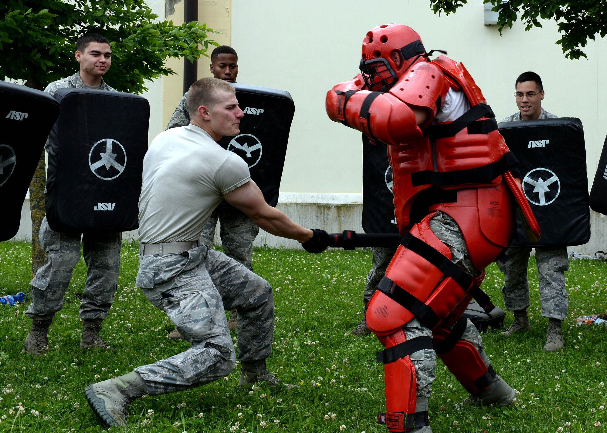 U.S. Air Force Senior Airman Mitchell Poppema, 31st Security Forces Squadron defender, strikes a simulated enemy during expandable baton training and certification, May 21, 2015, at Aviano Air Base, Italy. Defenders learned tactics to use against aggressive individuals who they may encounter on the job. (U.S. Air Force photo by Airman 1st Class Cary Smith/Released)
