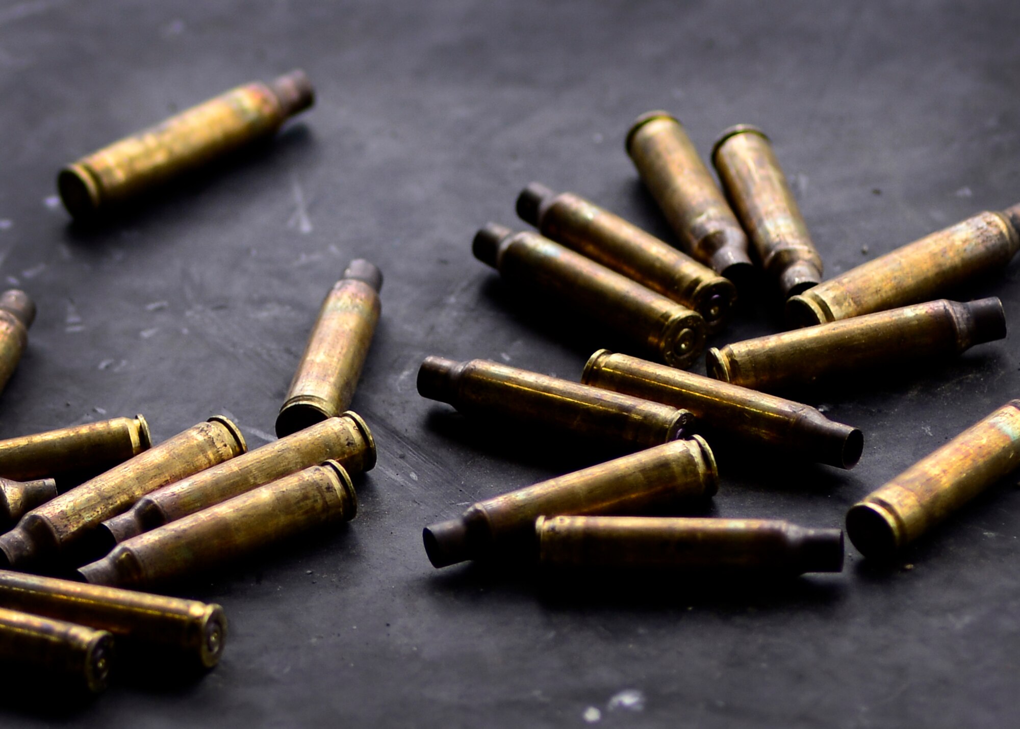 Used M4 carbine rounds are discharged to the ground as U.S. Air Force Airmen with the 31st Security Forces Squadron practice full distance shooting at the CAO Malnisio Range, May 21, 2015 in Pordenone, Italy. The Airmen were hand-selected by their squadron to serve as designated marksmen. (U.S. Air Force photo by Senior Airman Areca T. Wilson/Released)