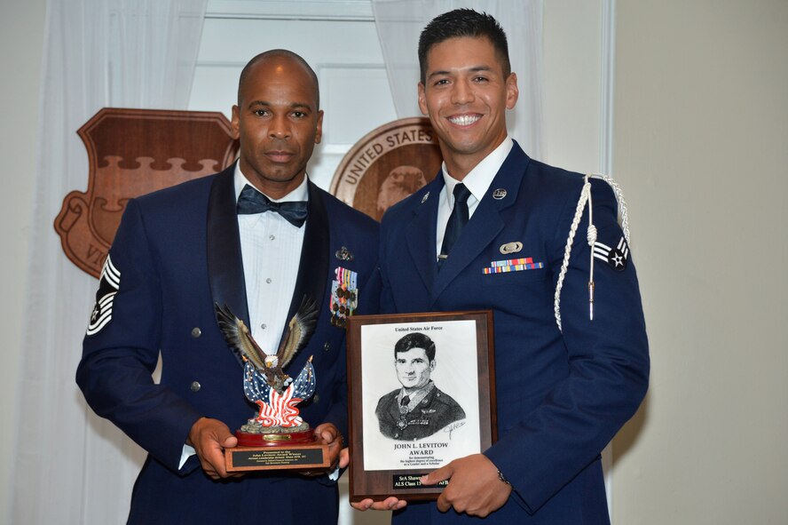 U.S. Air Force Senior Airman Shawn Shoults, 3rd Intelligence Squadron, receives the John L. Levitow Award for the Senior Master Sgt. David B. Reid Airman Leadership School Class 15-4, from Chief Master Sgt. Thomas Leggett, 20th Logistics Readiness Squadron superintendent, at Shaw Air Force Base, S.C., May 21, 2015. The Levitow Award is given to the graduate with the highest average of instructor and student points, and is the highest award in enlisted professional military education. (U.S. Air Force photo by Airman 1st Class Michael Cossaboom/Released)