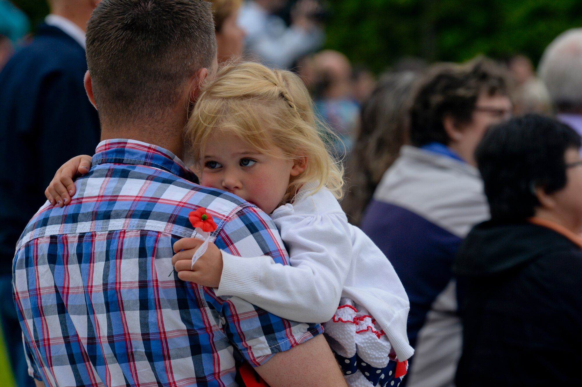 Hailey Wuenstel, 4, daughter of U.S. Air Force Maj. Scott Wuenstel, executive officer to the U.S. Air Forces in Europe vice commander, Ramstein Air Base, Germany, holds a memorial poppy during a Memorial Day ceremony at the Luxembourg American Cemetery and Memorial in Luxembourg, May 23, 2015. More than 300 Luxembourgers and Americans gathered at the cemetery to reflect on the sacrifices made by fallen U.S. service members. (U.S. Air Force photo by Staff Sgt. Joe W. McFadden/Released)  