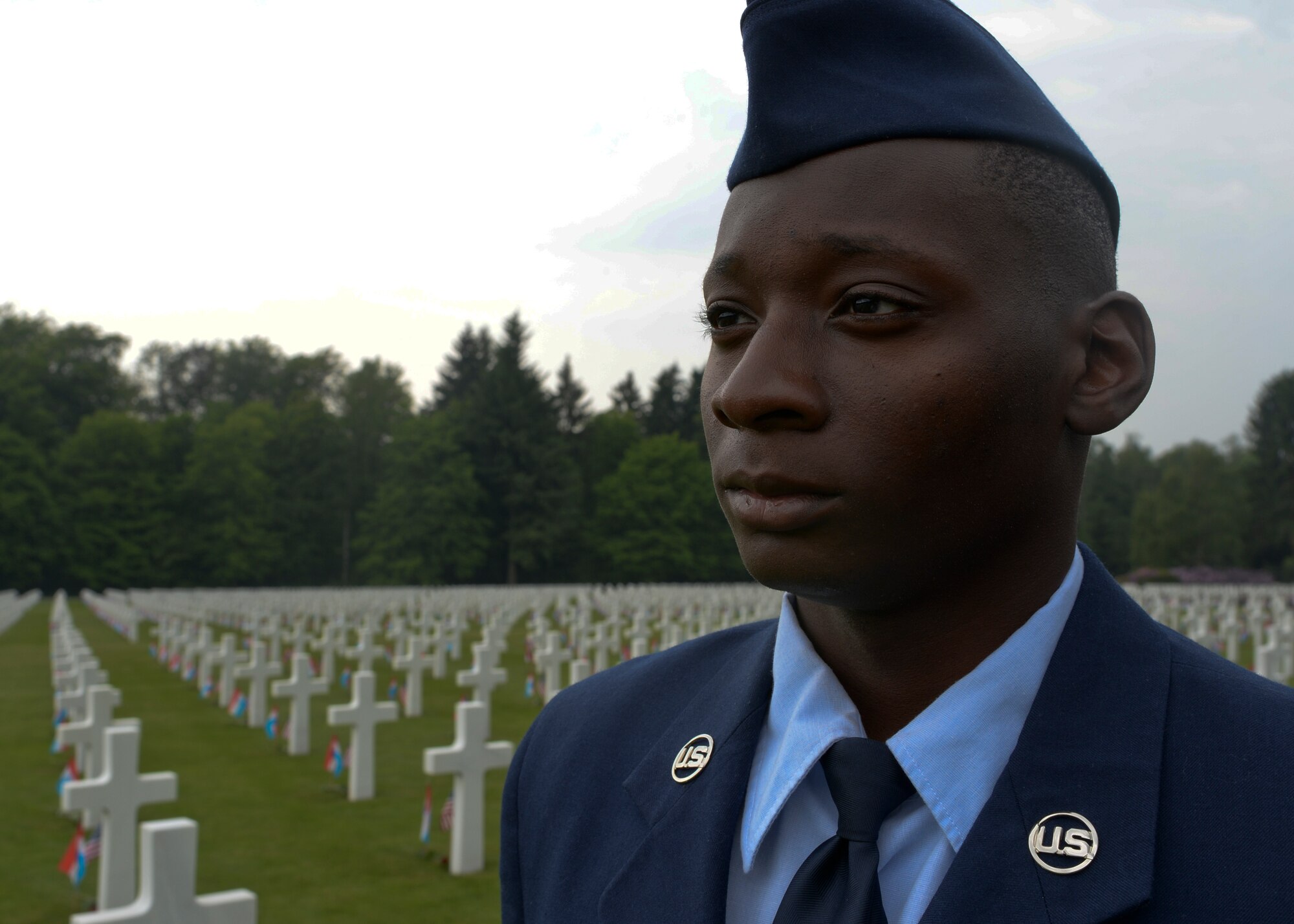 U.S. Air Force Airman 1st Class Xavier Meadows, a 52nd Equipment Maintenance Squadron precision-guided munitions apprentice, stands at parade rest before a Memorial Day ceremony at the Luxembourg American Cemetery and Memorial in Luxembourg, May 23, 2015. The base's Airmen also served as a ceremonial flight in service dress, caretakers of the cemetery's Luxembourg and U.S. flags, and escorts for guests to lay wreaths. (U.S. Air Force photo by Staff Sgt. Joe W. McFadden/Released)  