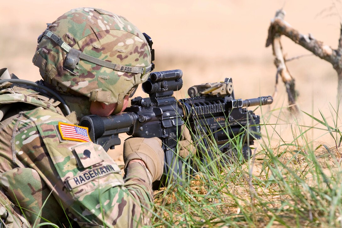 U.S. Army Spc. Matthew Hagemann fires at targets during a joint live-fire exercise at the Great Lithuanian Hetman Jonusas Radvila Training Regiment in Rukla, Lithuania, May 22, 2015. Hagemann is assigned to 3rd Infantry Division's Team Eagle, Task Force 2nd Battalion, 7th Infantry Regiment, 1st Armored Brigade Combat Team.